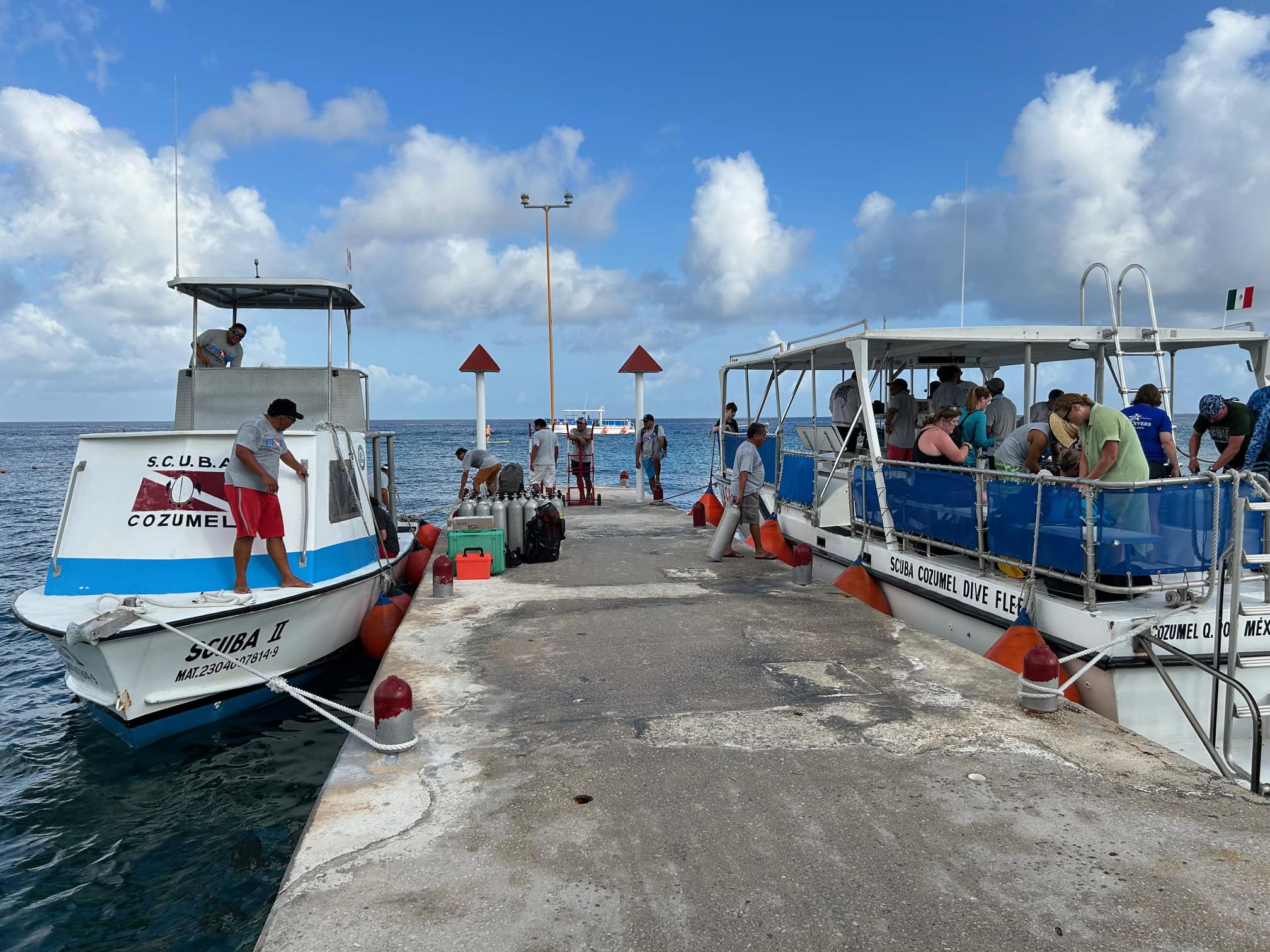 Scuba-Diving-Cozumel Dive staff loading scuba diving tanks and passengers loading into boats.