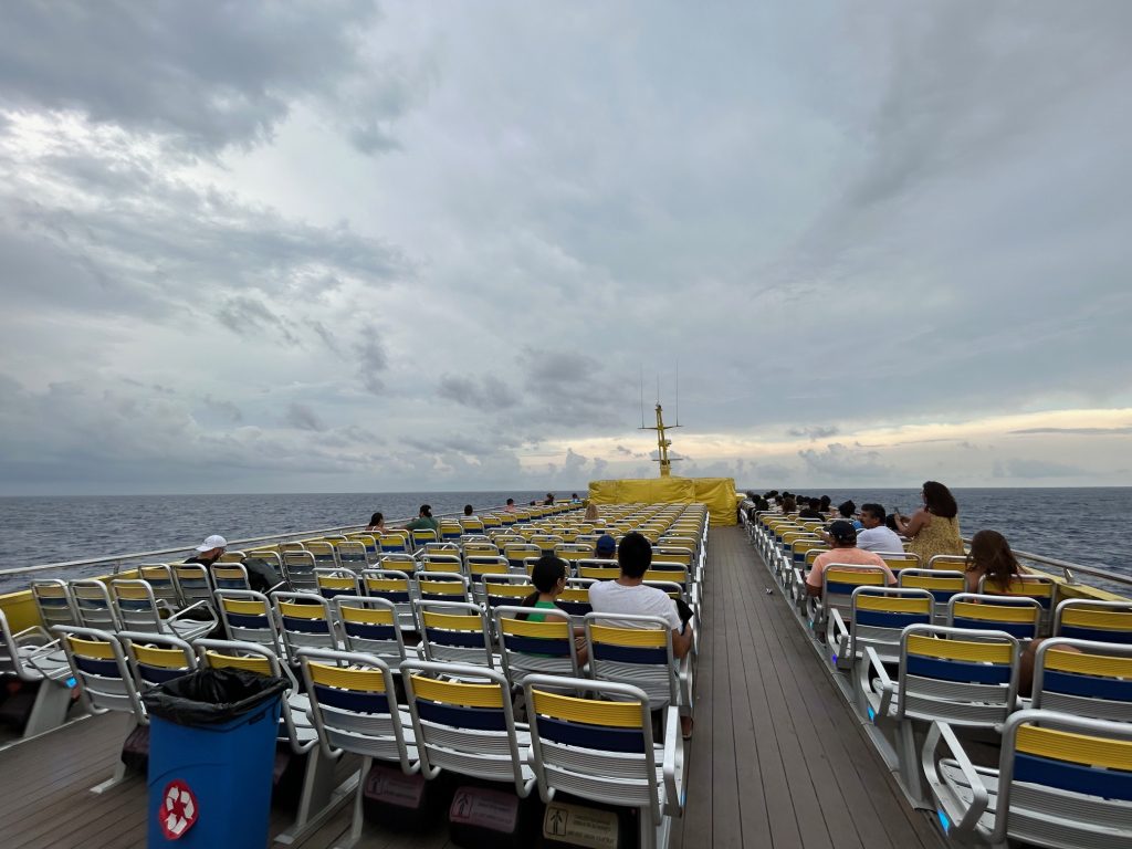 ferry to cozumel with passengers sitting on the upper deck
