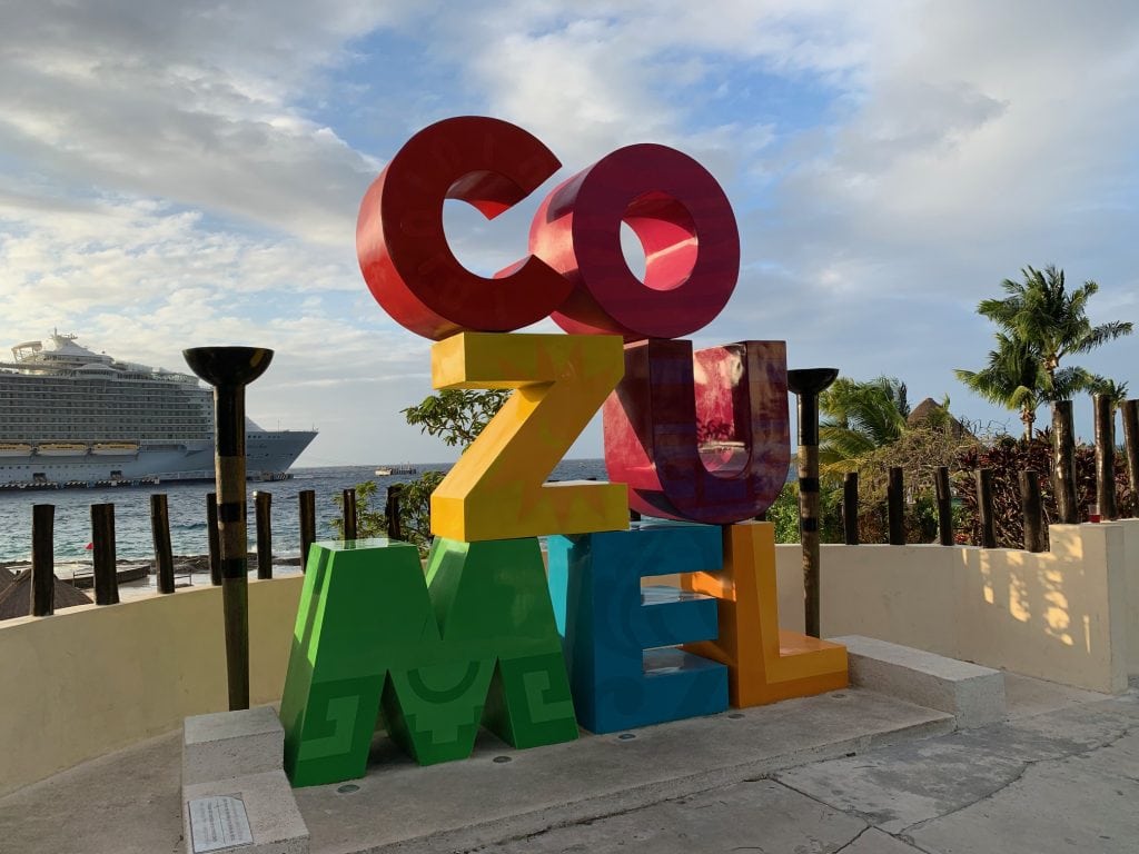 Colourful Cozumel Letters with a cruise ship in the background.