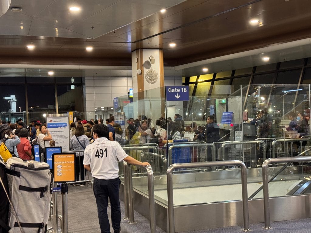 A picture of terminal 1 at the Manila airport with an overcrowded boarding area.