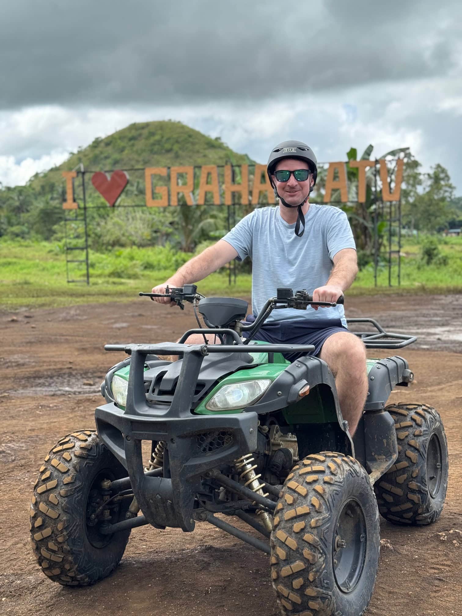Tourist riding an ATV through the Chocolate Hills in Bohol, an adventurous way to explore this iconic site.