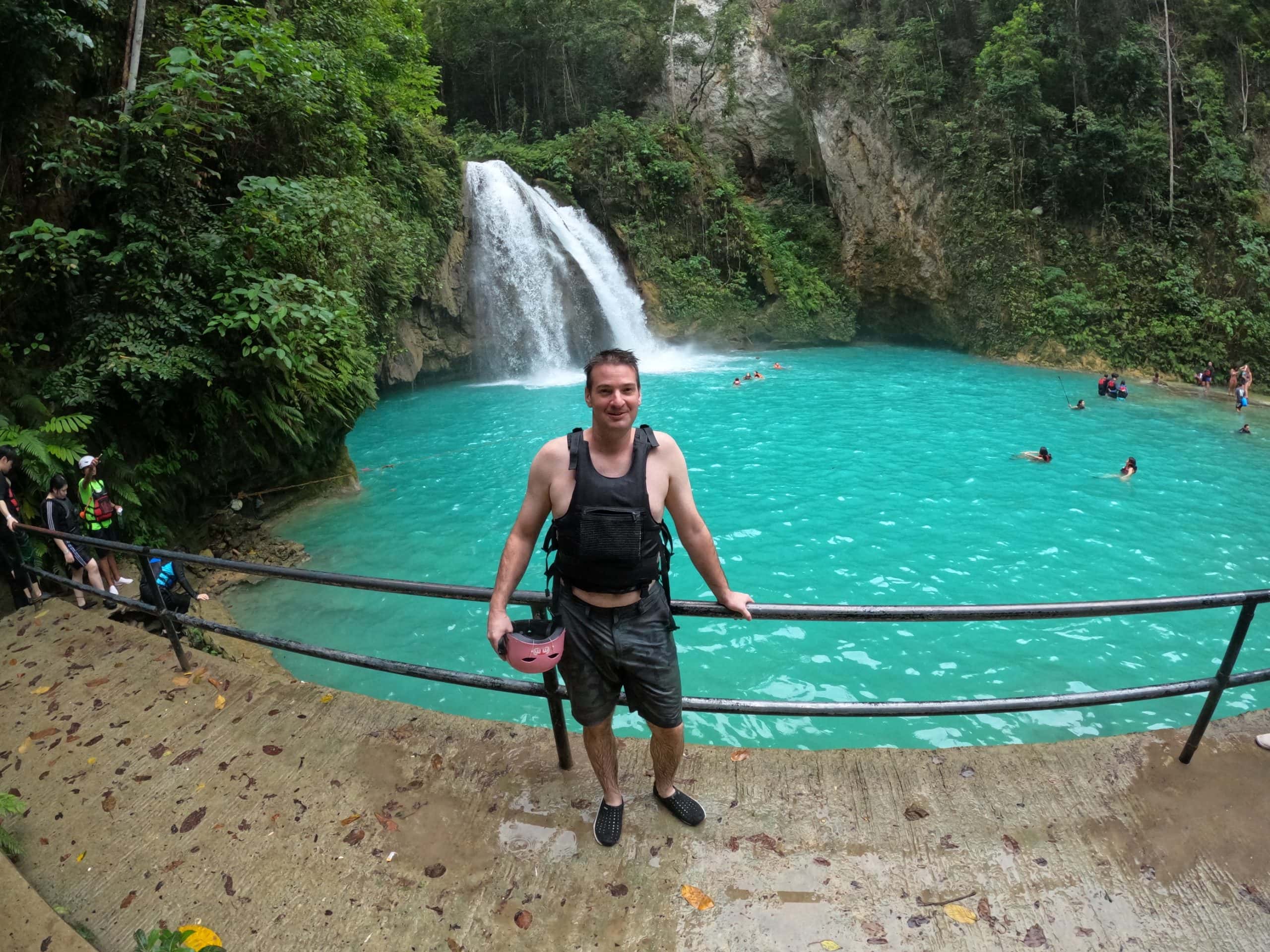 Adventurers jumping into turquoise waters during a canyoneering trip to Kawasan Falls near Moalboal.
