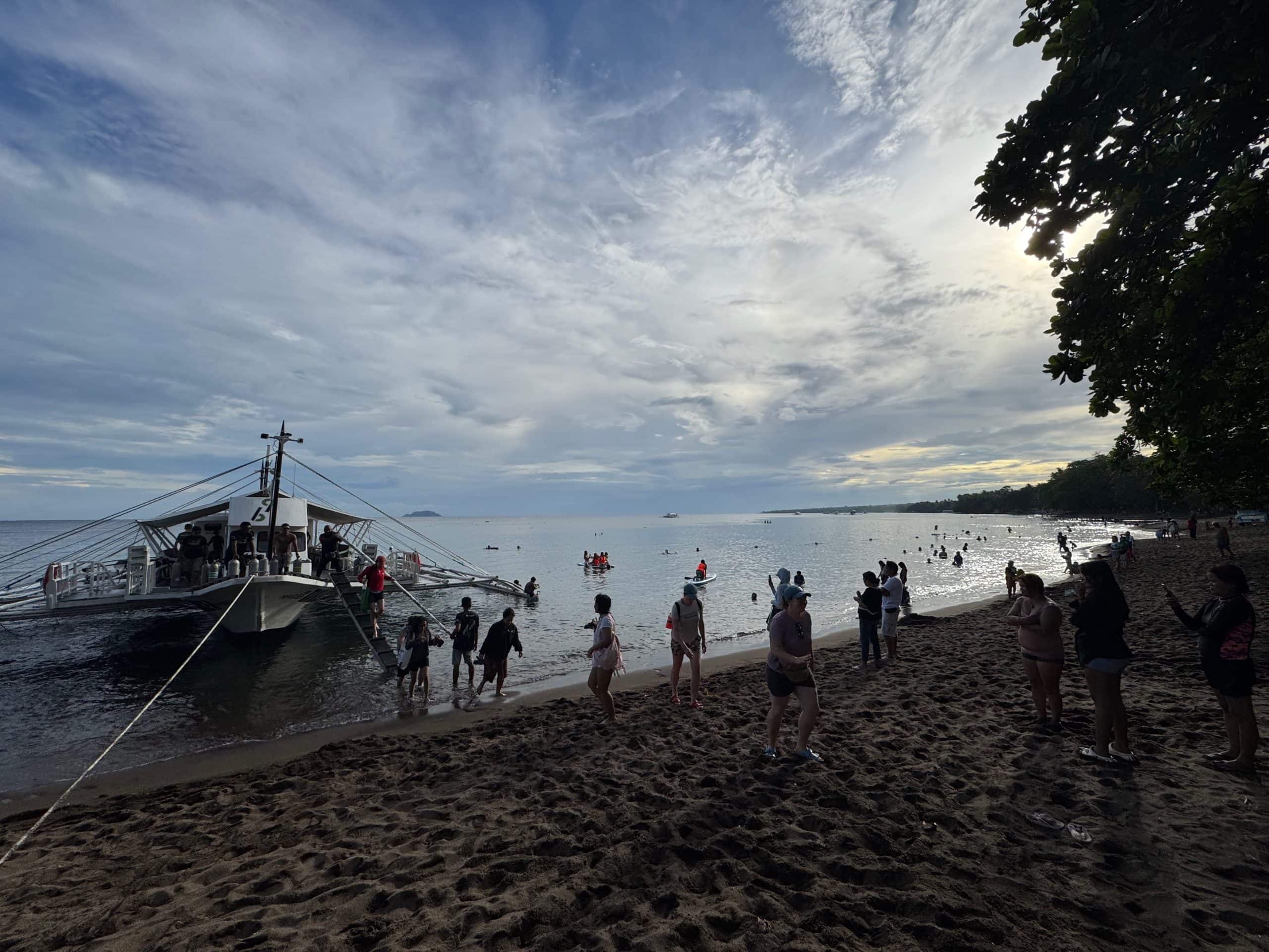 Peaceful beachfront view at sunrise in Dauin, a quiet dive destination perfect for underwater macro photography.