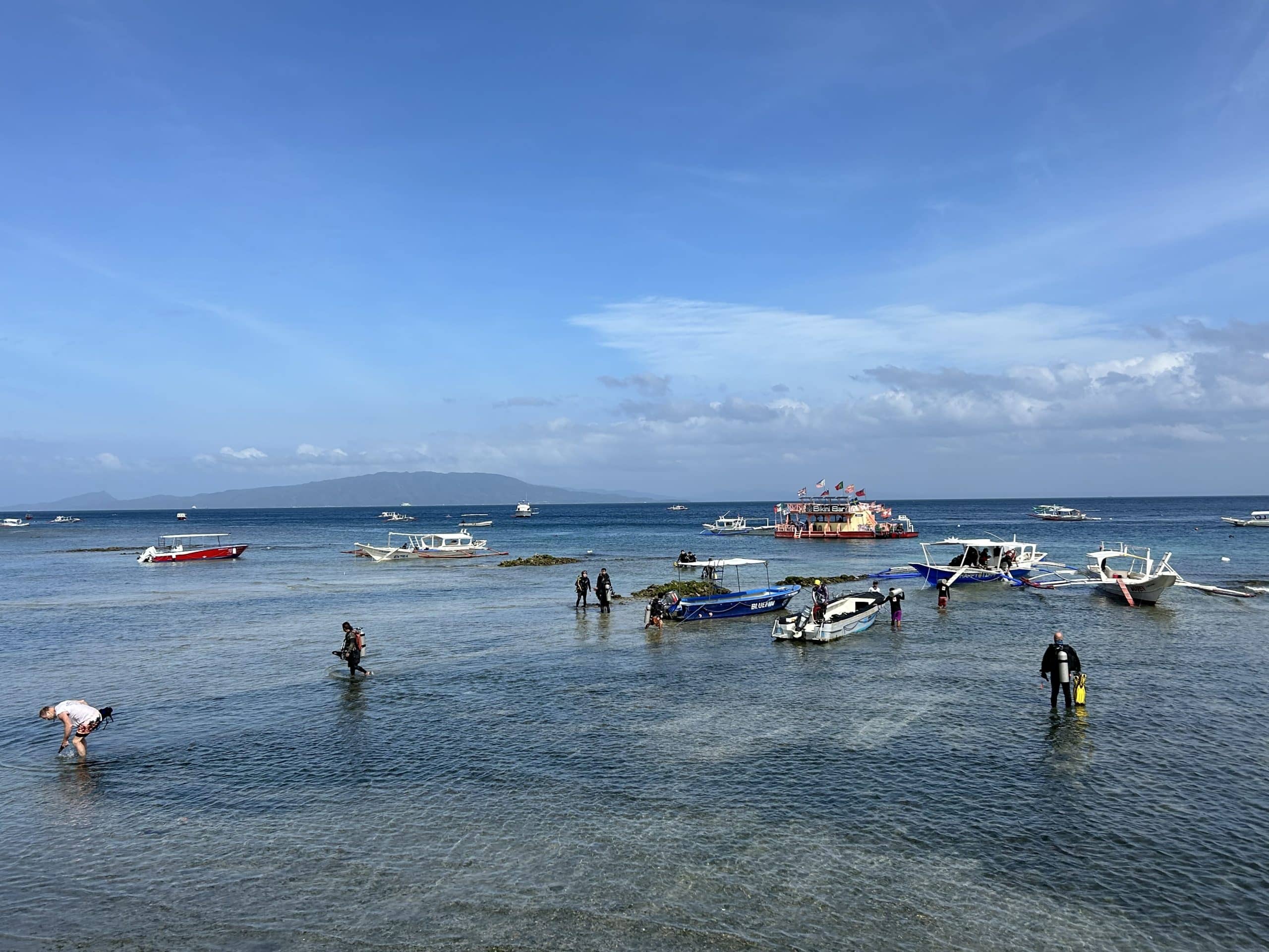 Sabang beach with dive boats in Puerto Galera, Mindoro