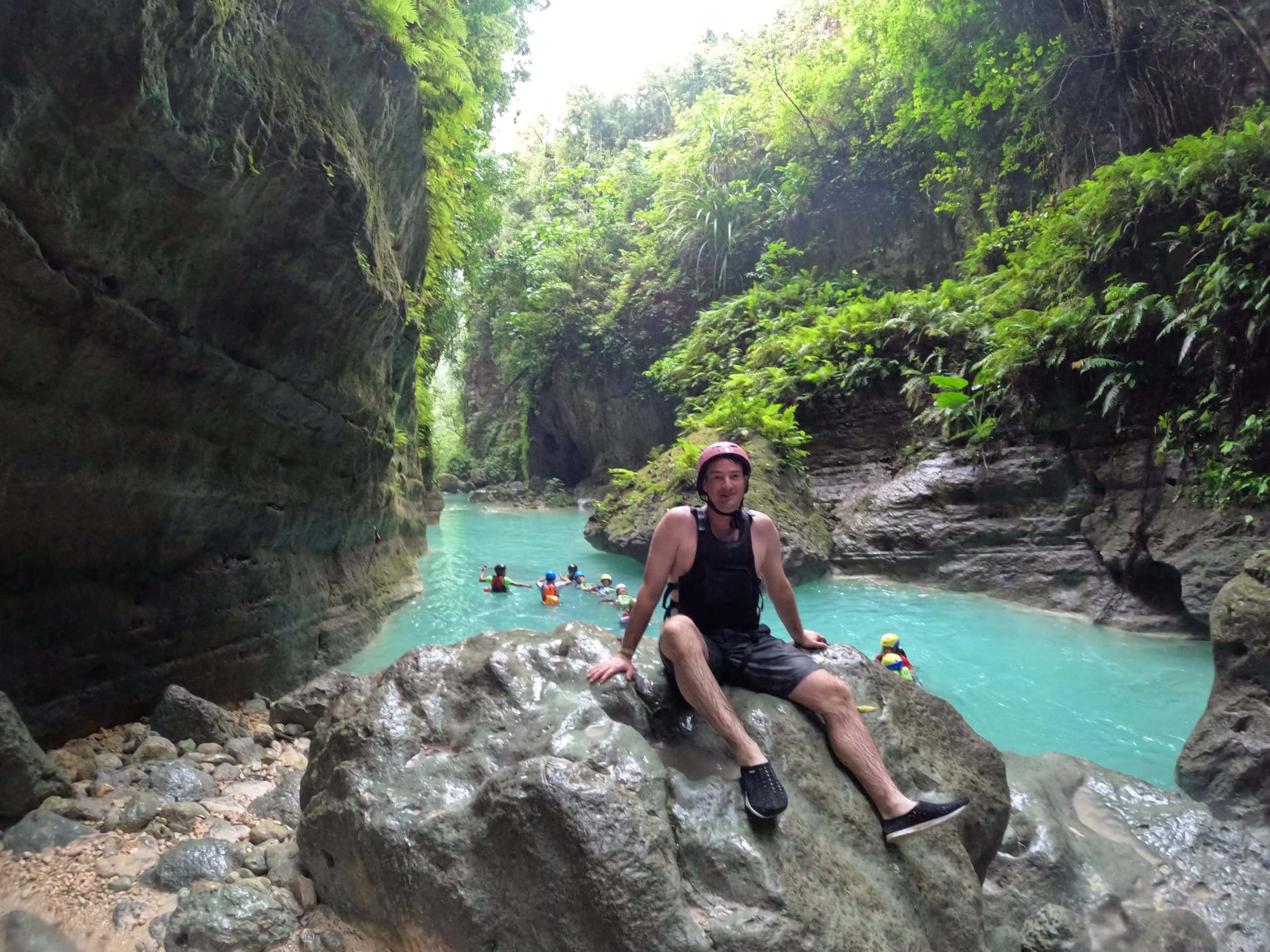 Cascading turquoise water at Kawasan Falls surrounded by lush jungle in Badian, Cebu.