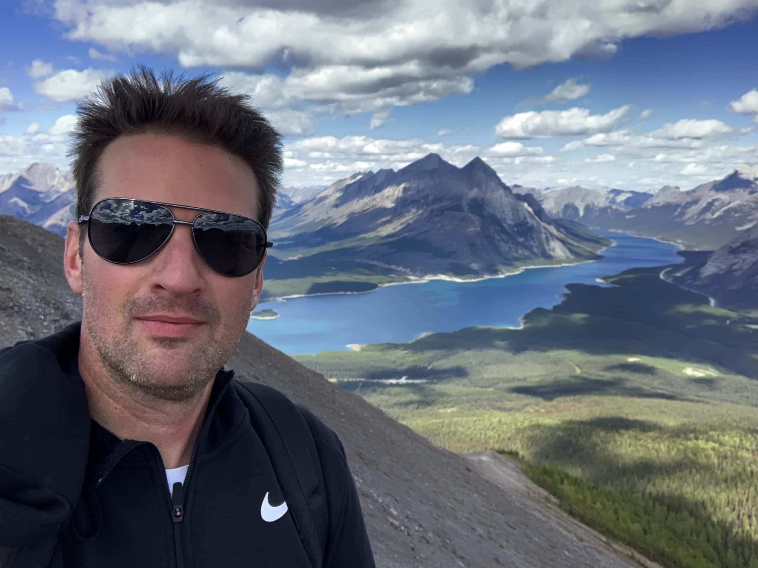 Group hiking a scenic mountain trail near Calgary in summer.