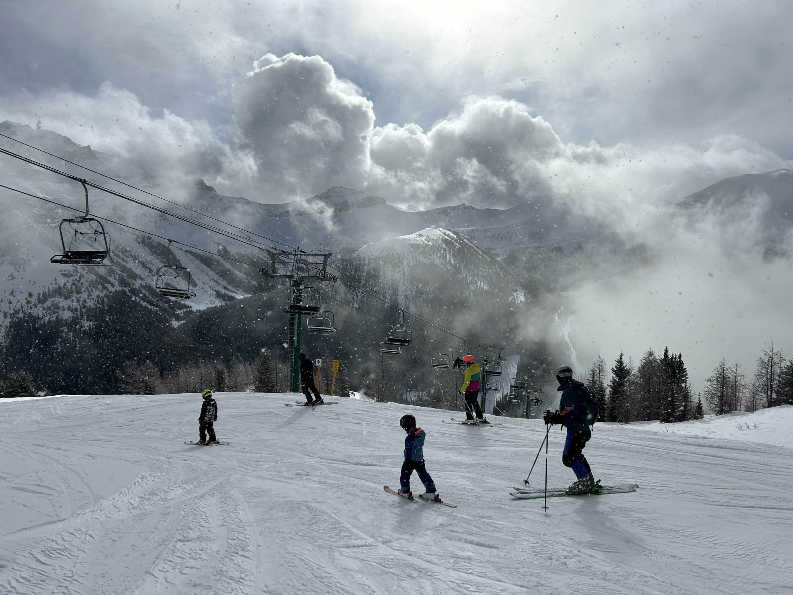 Skier descending a snowy slope in the Canadian Rockies near Calgary.