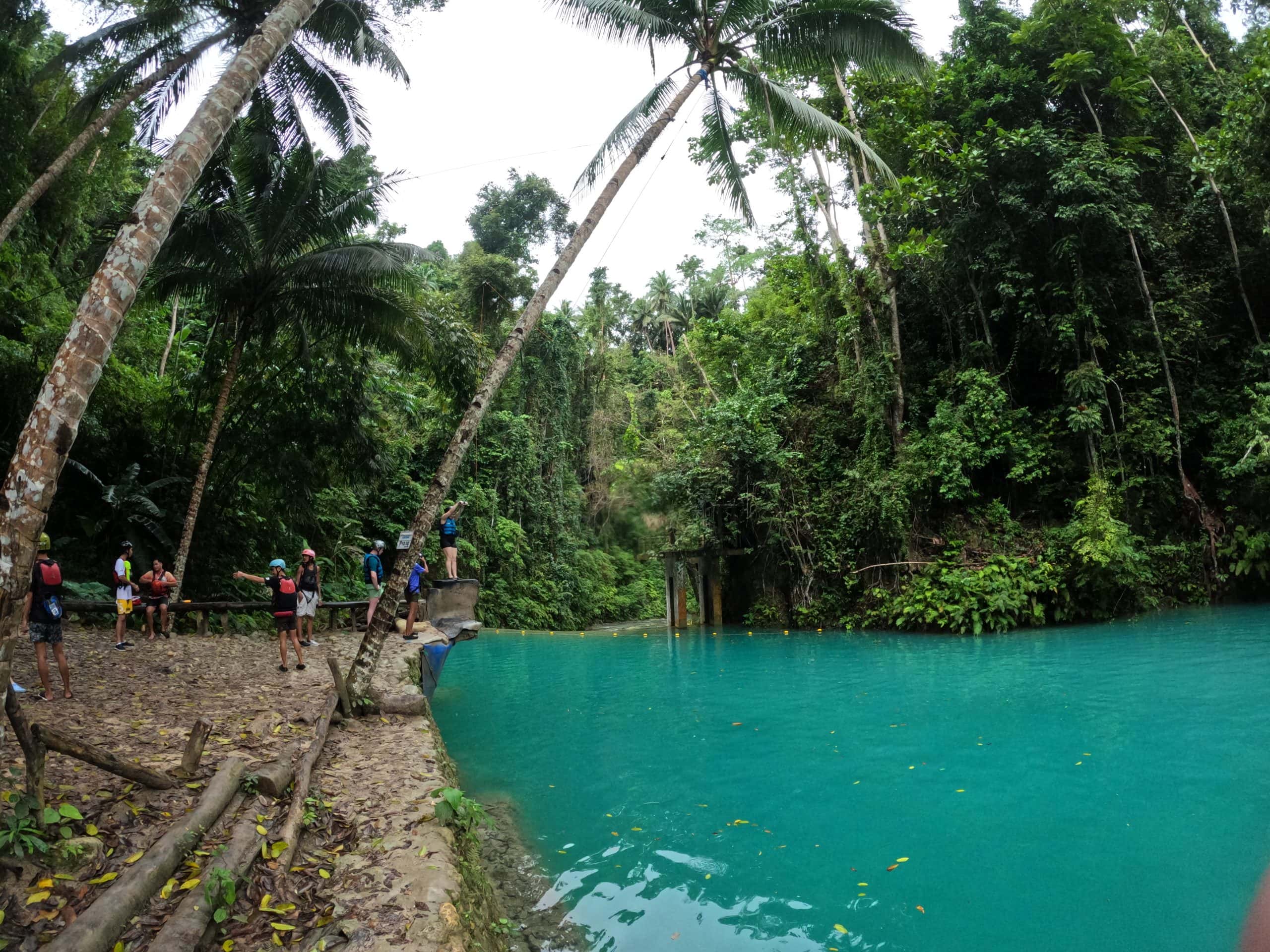 Guided group ascending rocks and waterfalls during the adrenaline-filled Kawasan adventure.