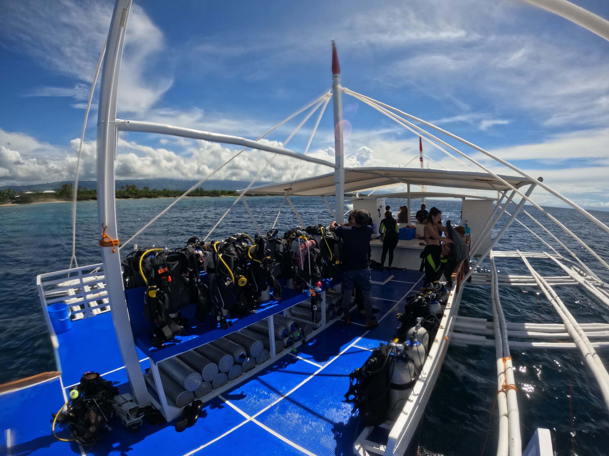 Surface view of a Moalboal dive boat used for exploring sites like Cathedral and Pescador Island.