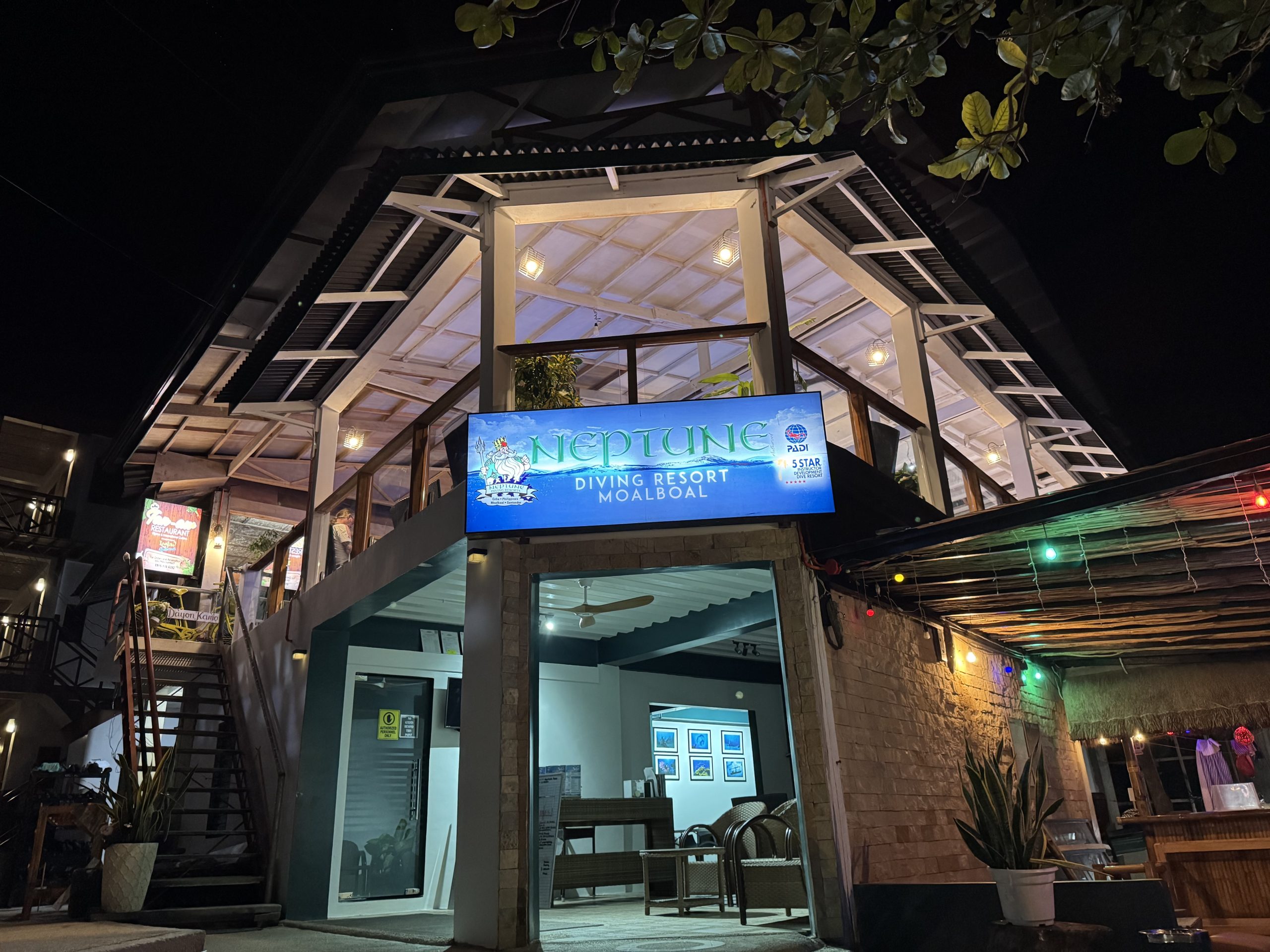 Nighttime view of the exterior of Neptune Dive Resort 