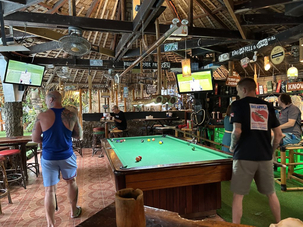 lively Sabang sports bar The Big Apple Dive Resort with pool tables, cold drinks, and expats watching live games