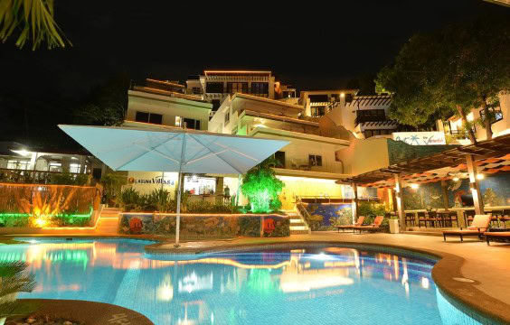 night view of Lalaguna Villas Luxury Dive Resort in Sabang with a lit swimming pool, upscale suites, and relaxed tropical ambiance