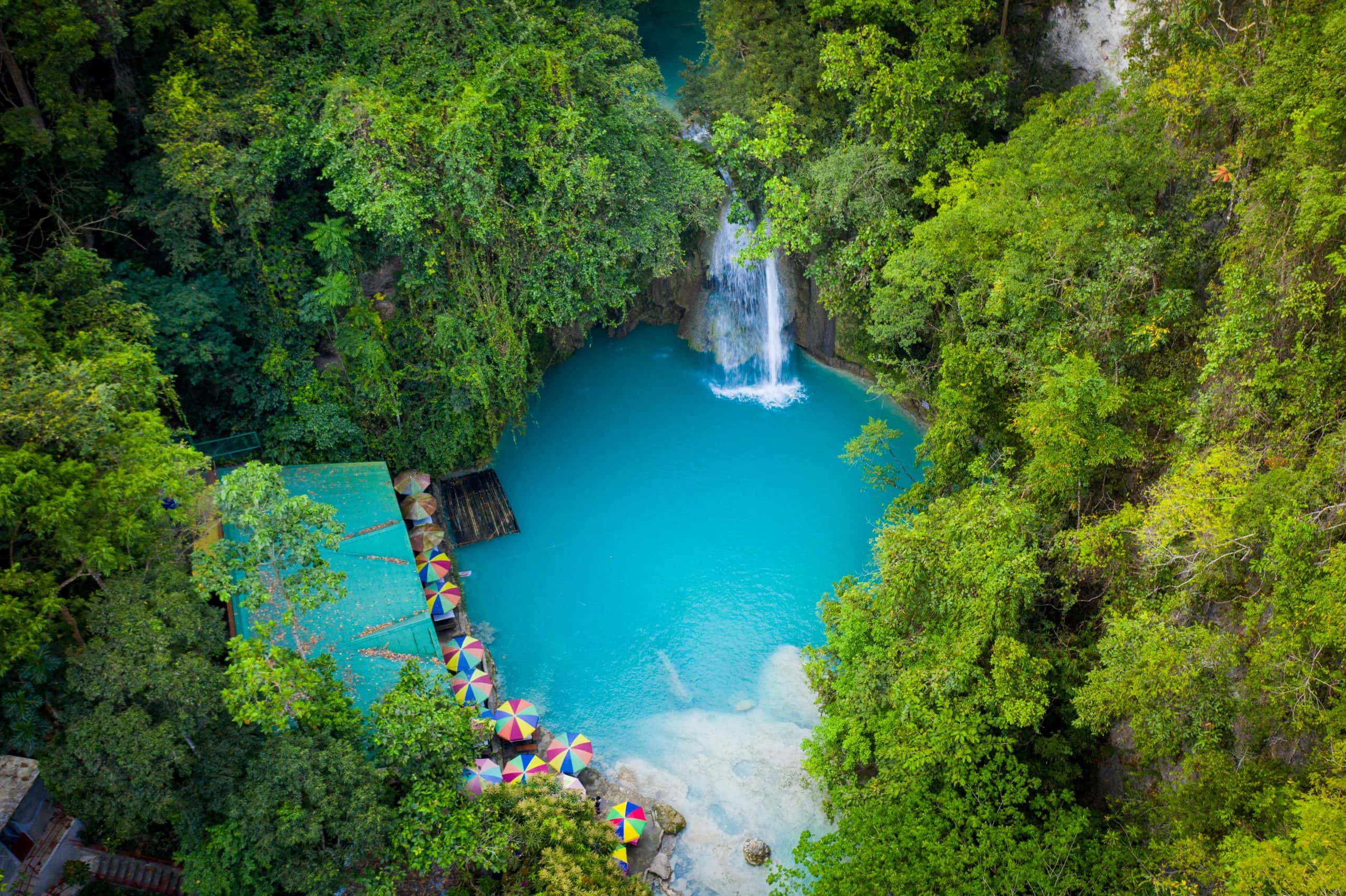 Aerial view of Kawasan Falls surrounded by lush jungle in Cebu, Philippines — a must-visit canyoneering destination near Moalboal.