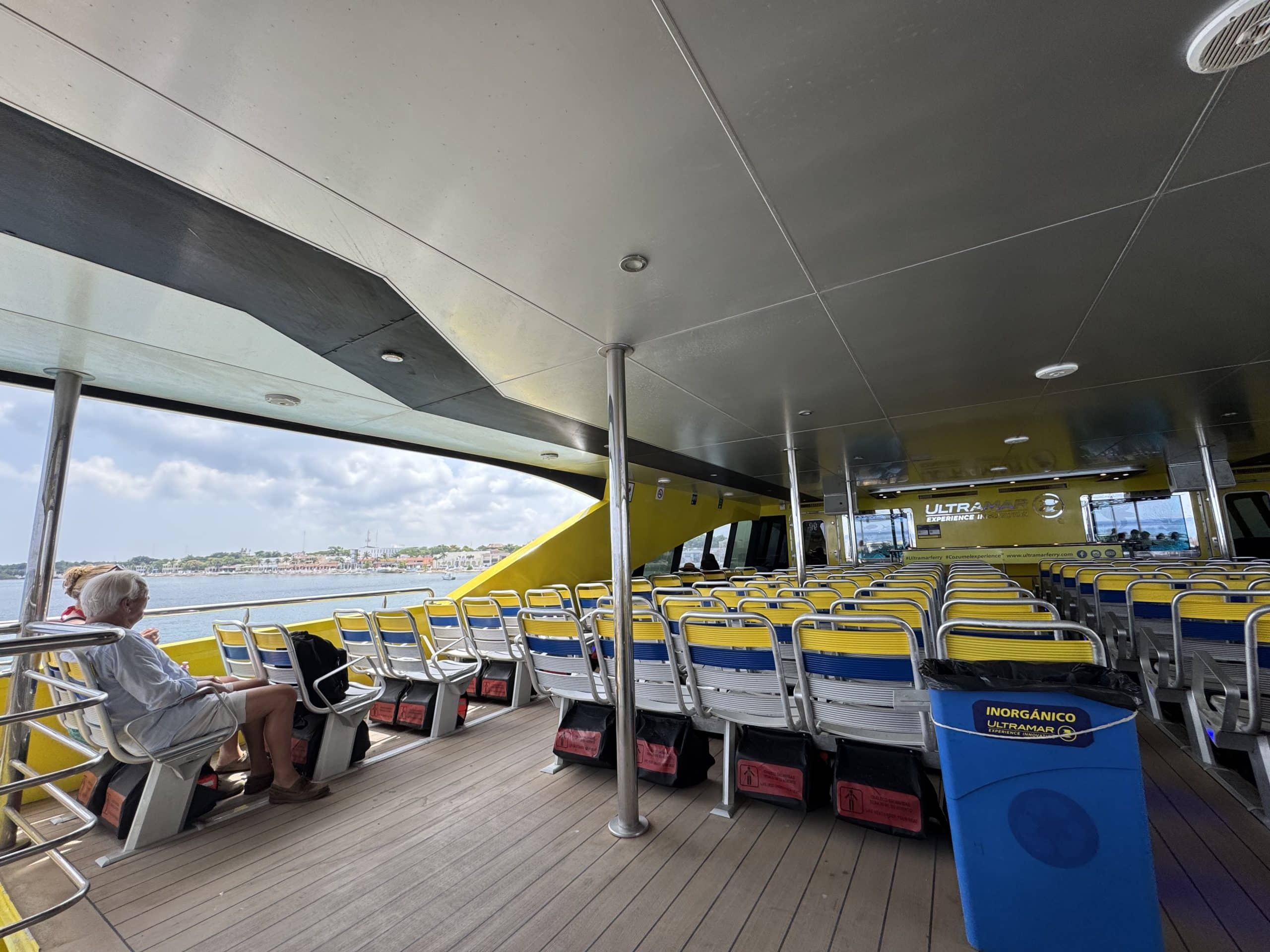 Spacious and shaded upper deck seating aboard the Cozumel ferry, offering ocean views during the 40-minute ride from Playa del Carmen.