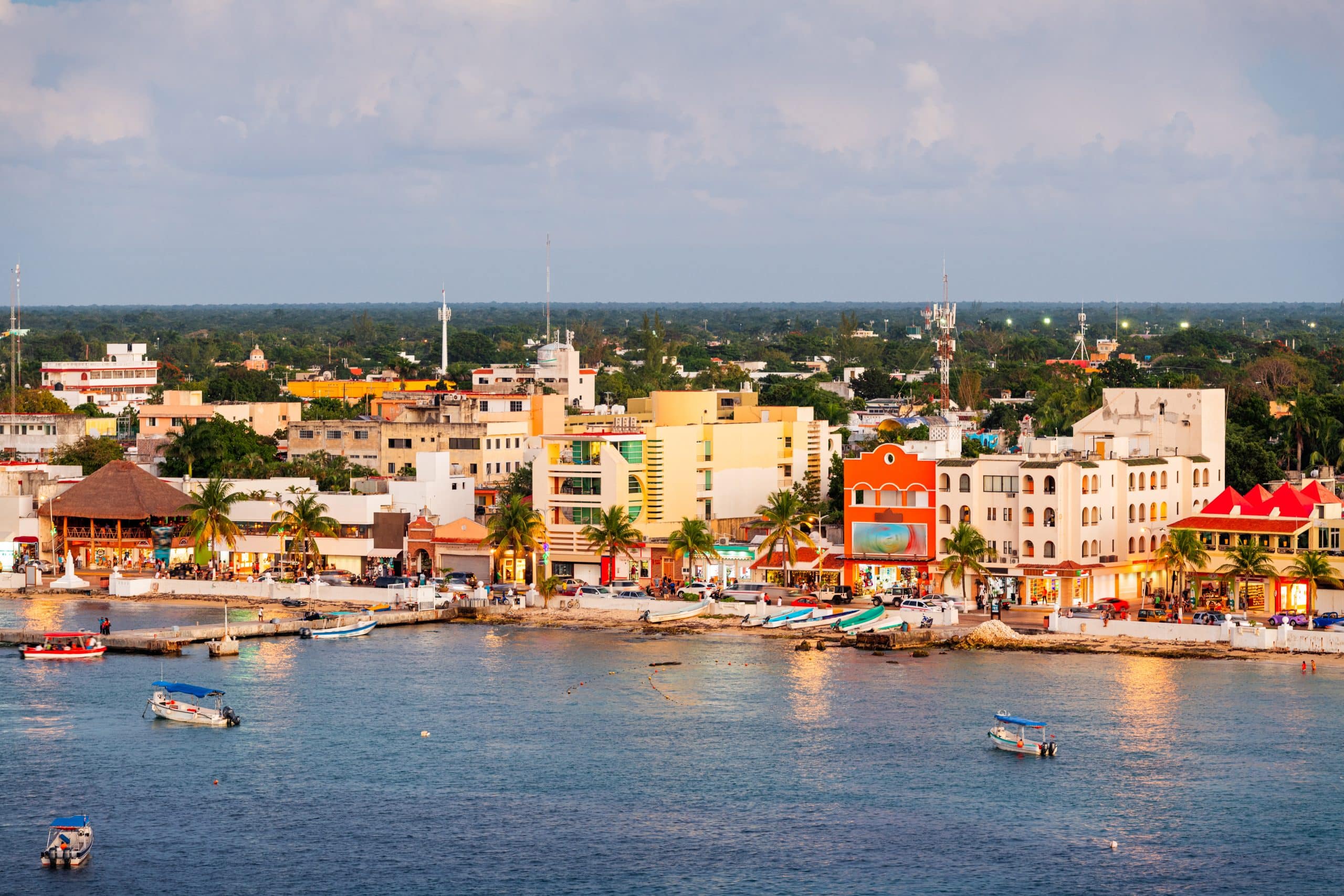 Colourful waterfront buildings and boats along the coast of San Miguel de Cozumel, the island’s vibrant downtown area in Mexico.