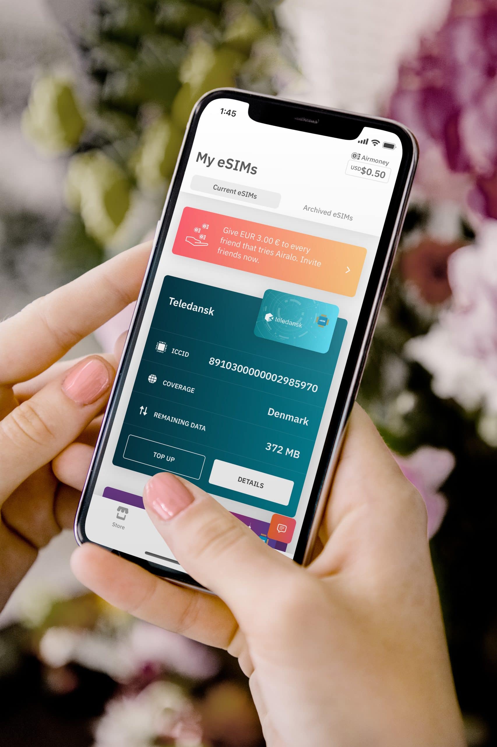 Person using a smartphone app to manage eSIM data plans, checking mobile connectivity options for international travel.