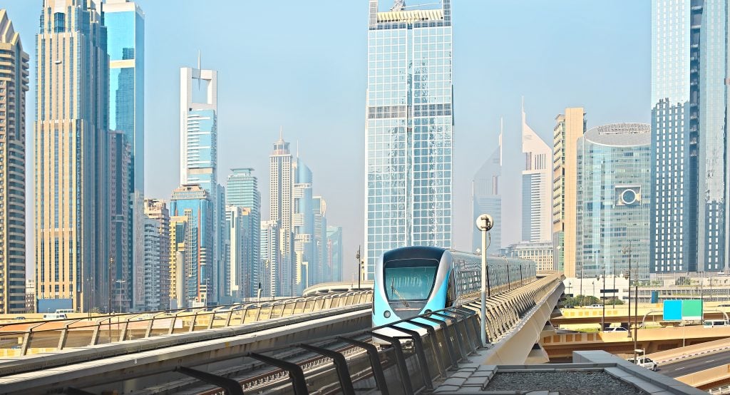 Metro and skyscrapers. Dubai metro railway in a summer day, United Arab Emirates