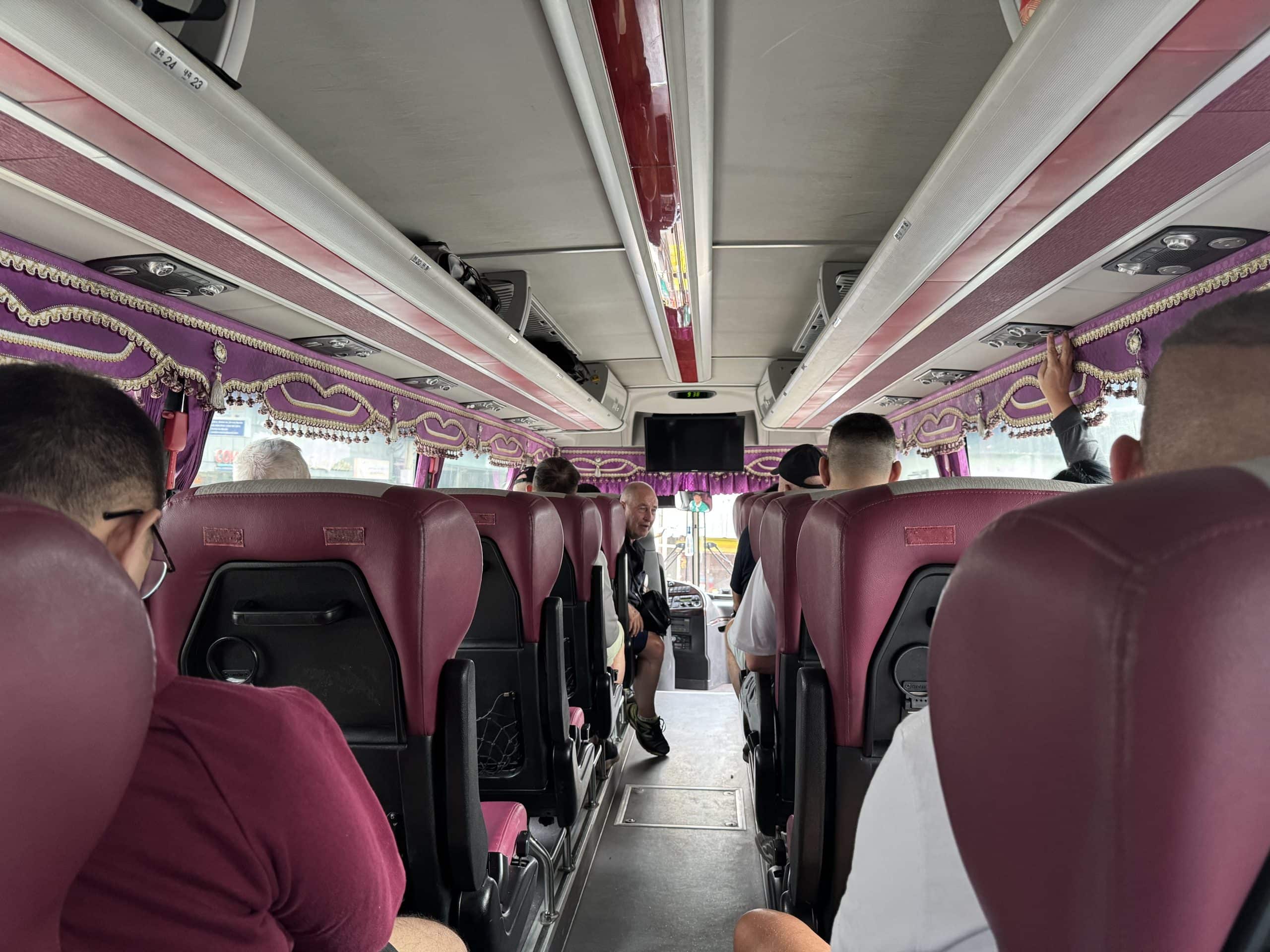 Interior of the Sikat bus from Manila to Batangas Port, showing comfortable reclining seats, air conditioning, and a spacious, coach style layout for the journey to Puerto Galera.