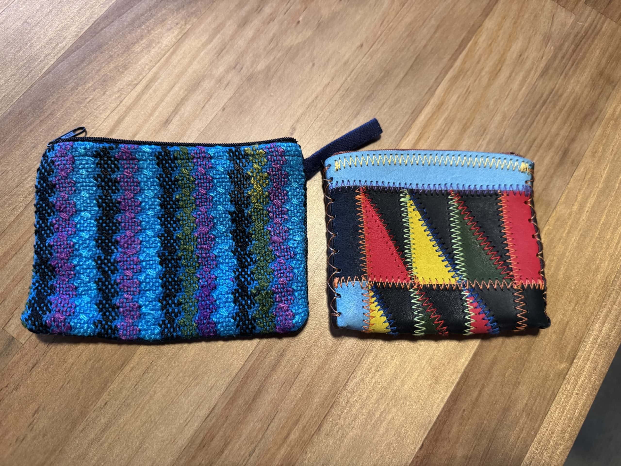 Two small coin pouches used to organize cash and loose change while travelling.