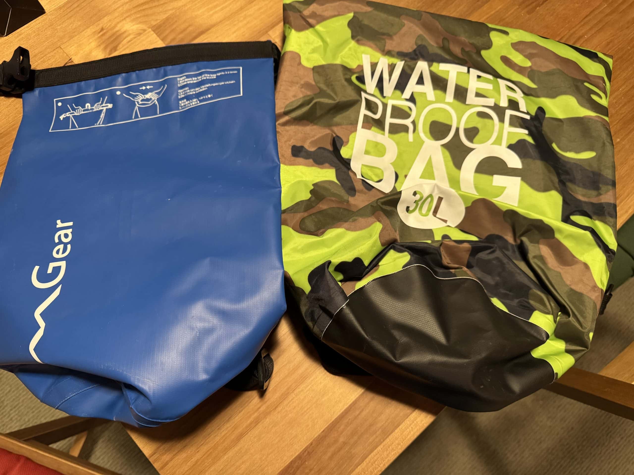 Waterproof dry bags used for travel, snorkelling, and boat trips, including a roll top backpack style and a 30L camo dry bag for keeping gear safe and dry.