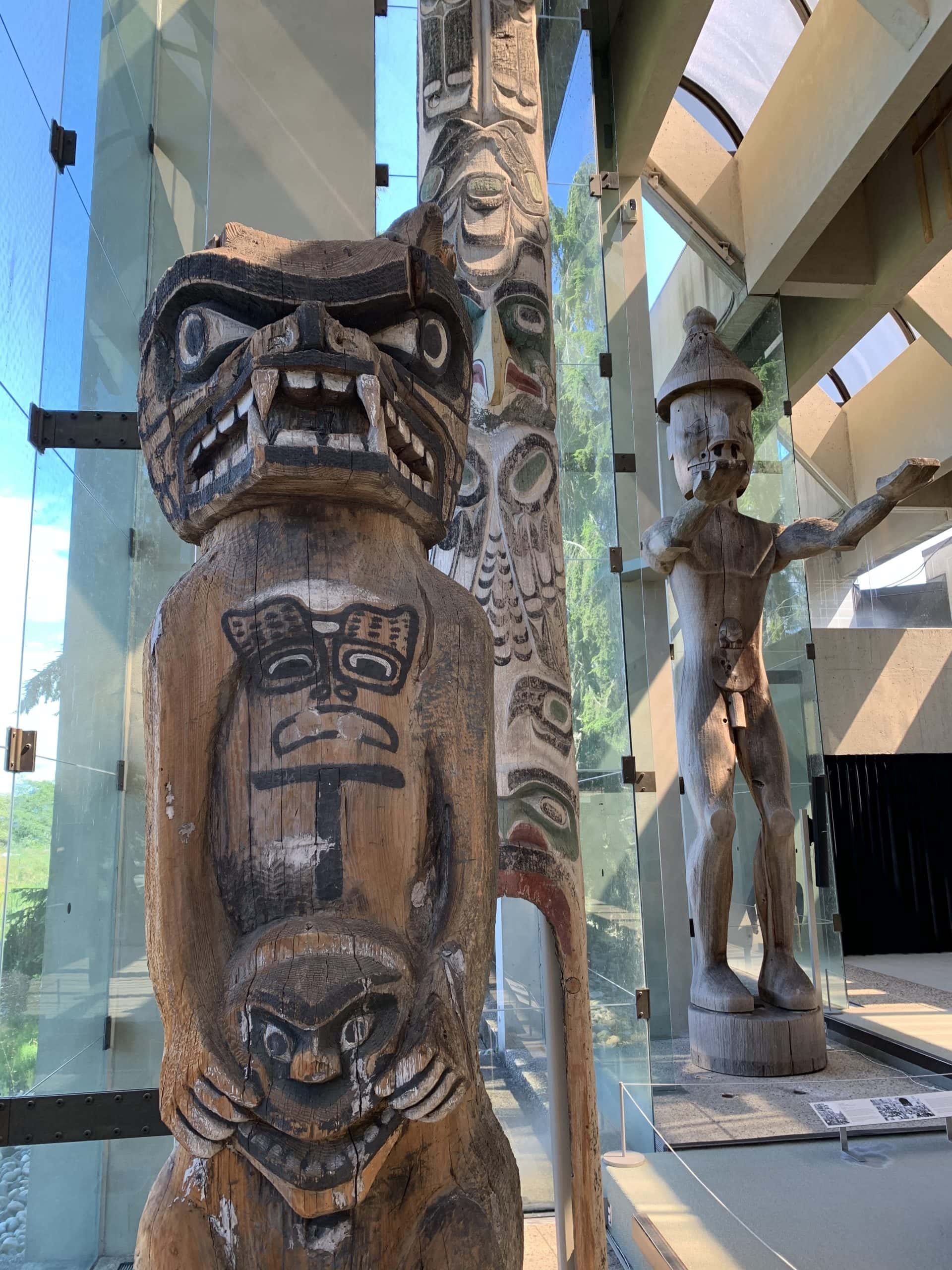 Traditional Northwest Coast Indigenous totem poles and carved figures displayed inside the Museum of Anthropology at the University of British Columbia in Vancouver