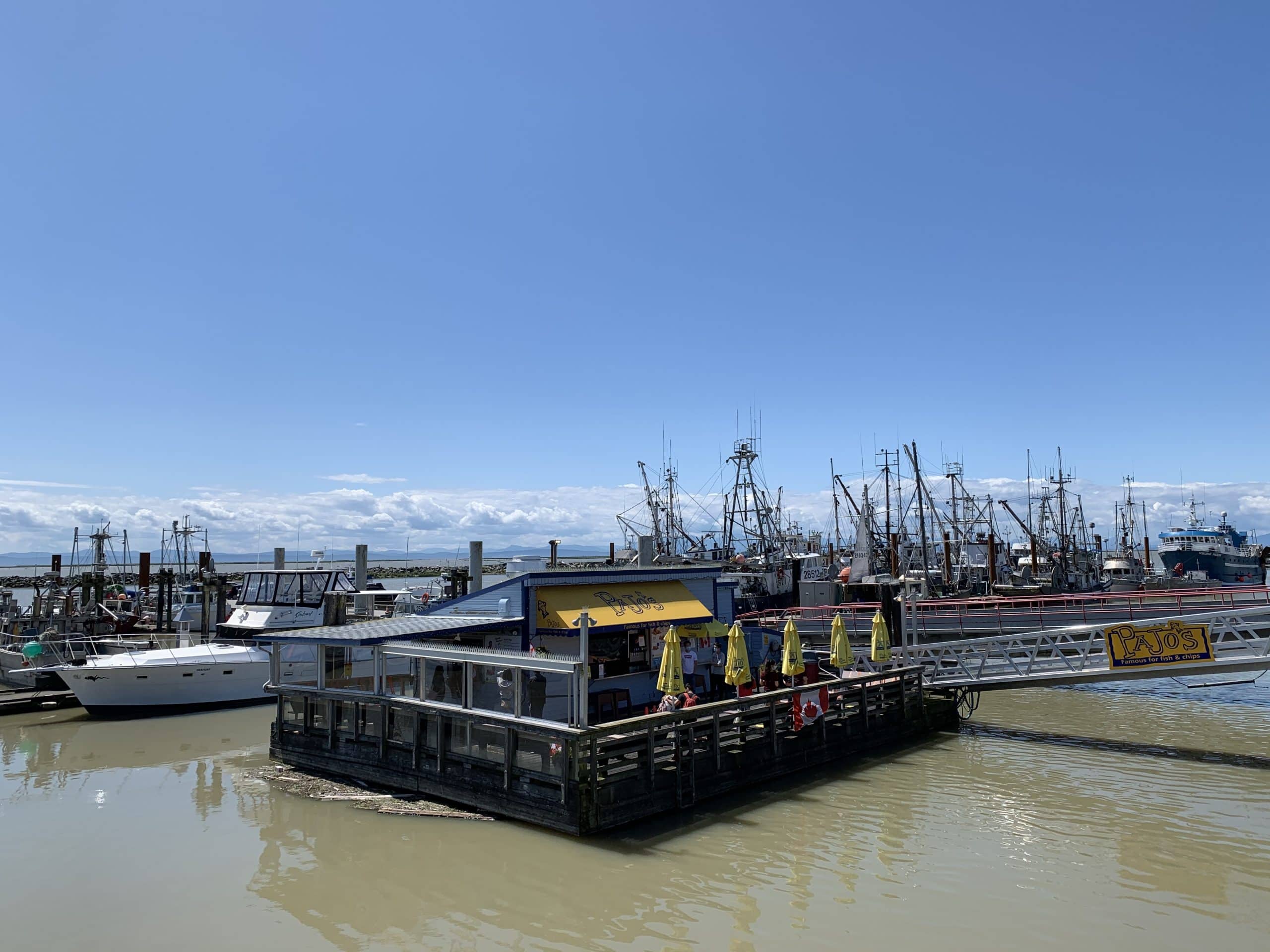 Floating seafood restaurant and fishing boats at Steveston Fisherman’s Wharf in Richmond, British Columbia near Vancouver