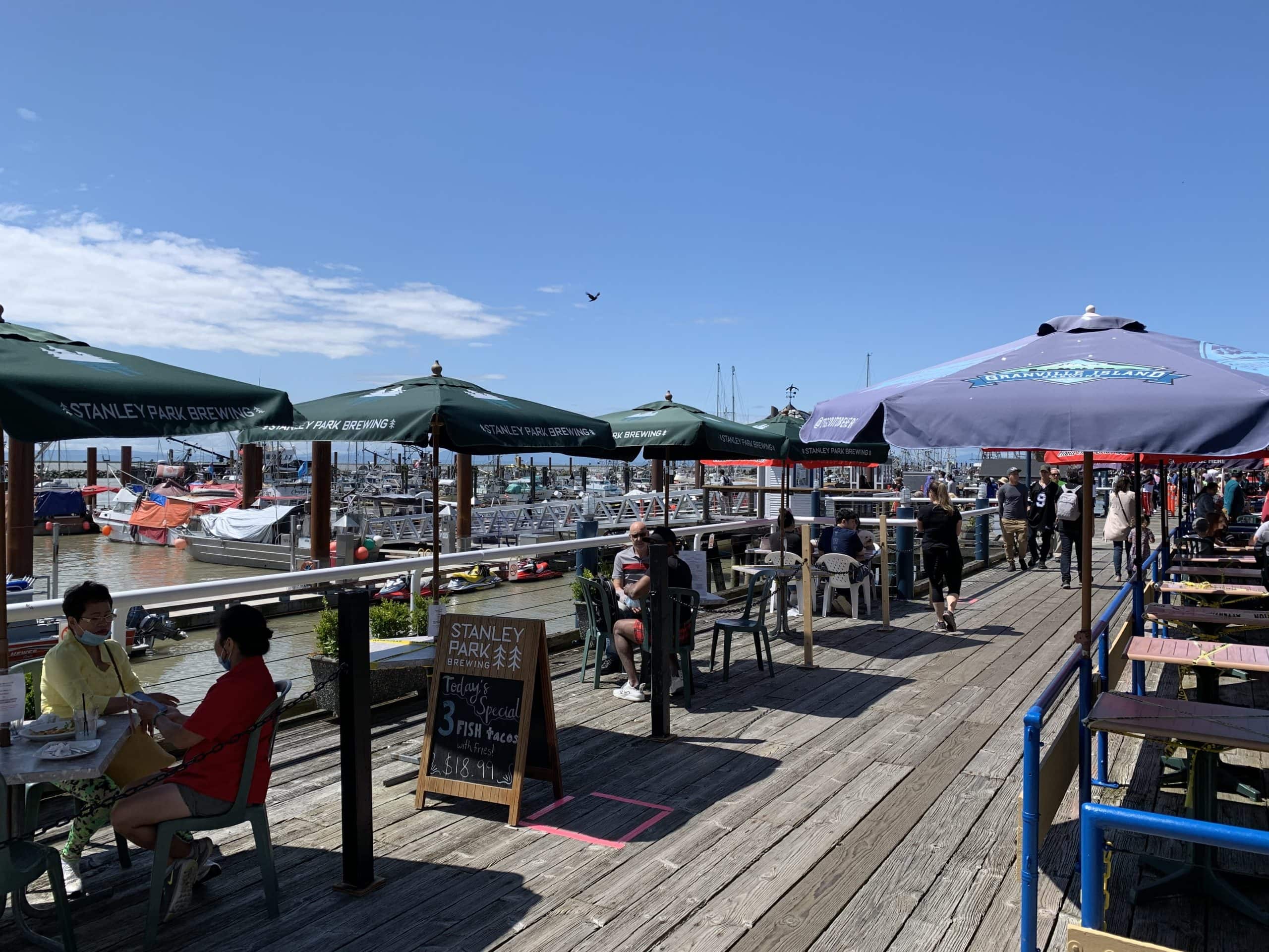 Outdoor waterfront patio dining and marina boardwalk at Steveston Fisherman’s Wharf in Richmond, British Columbia near Vancouver