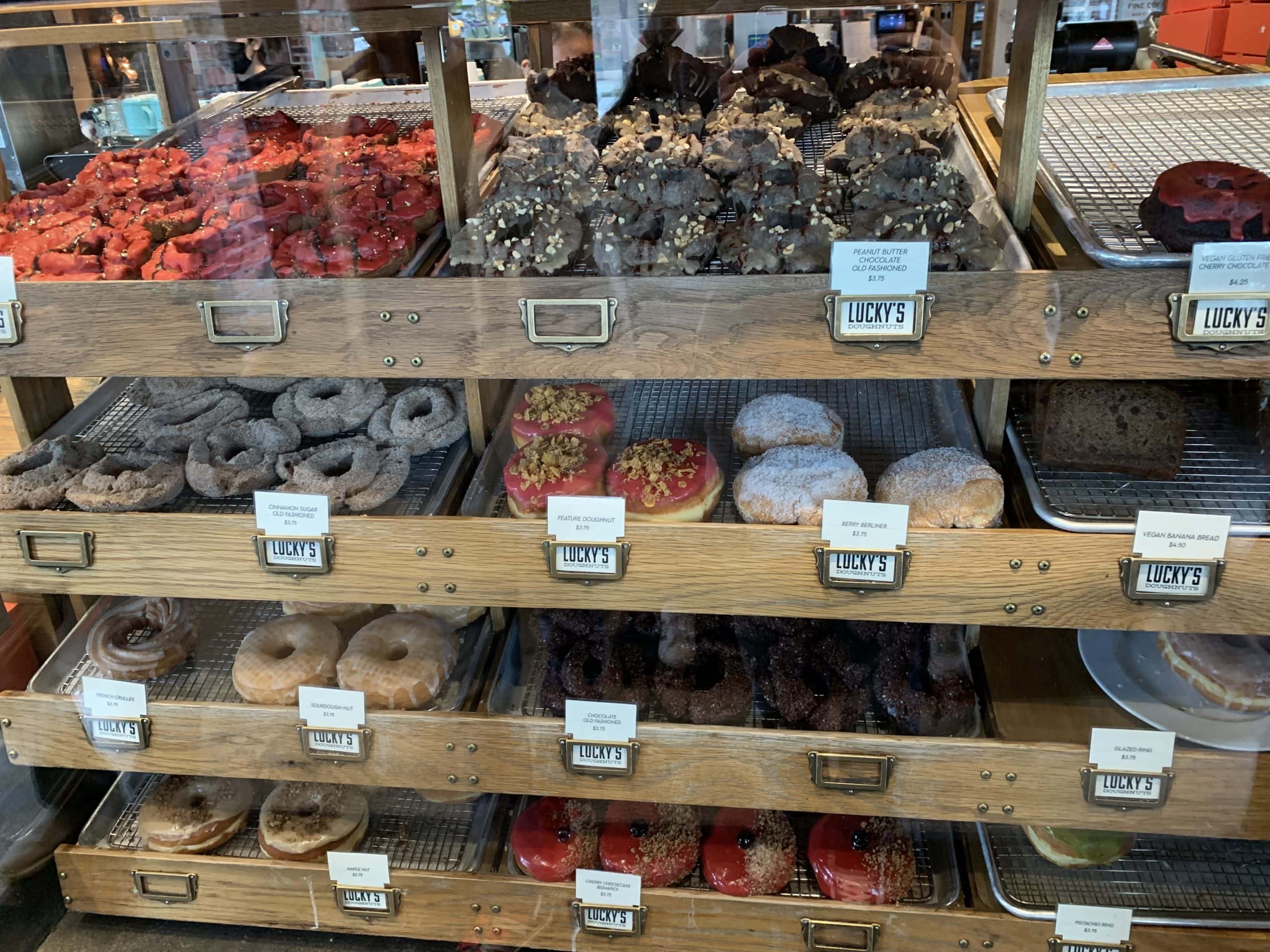 Display of freshly made gourmet doughnuts at Lucky’s Doughnuts bakery with assorted flavours and toppings in Vancouver, British Columbia
