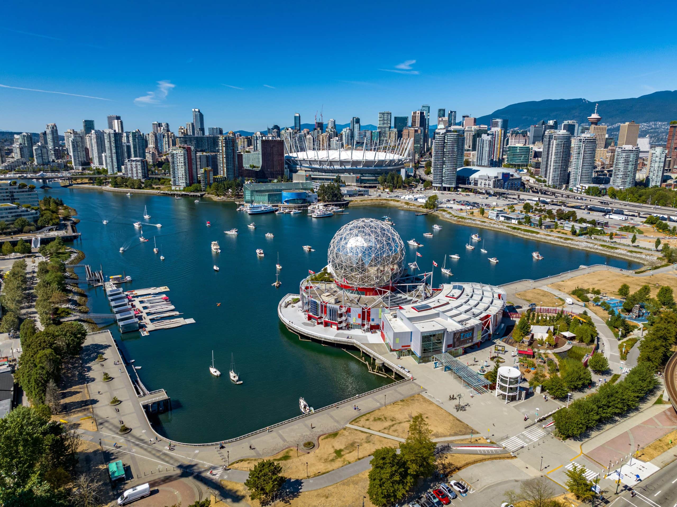 Aerial view of Science World at Telus World of Science with False Creek, BC Place Stadium, and the downtown Vancouver skyline in British Columbia