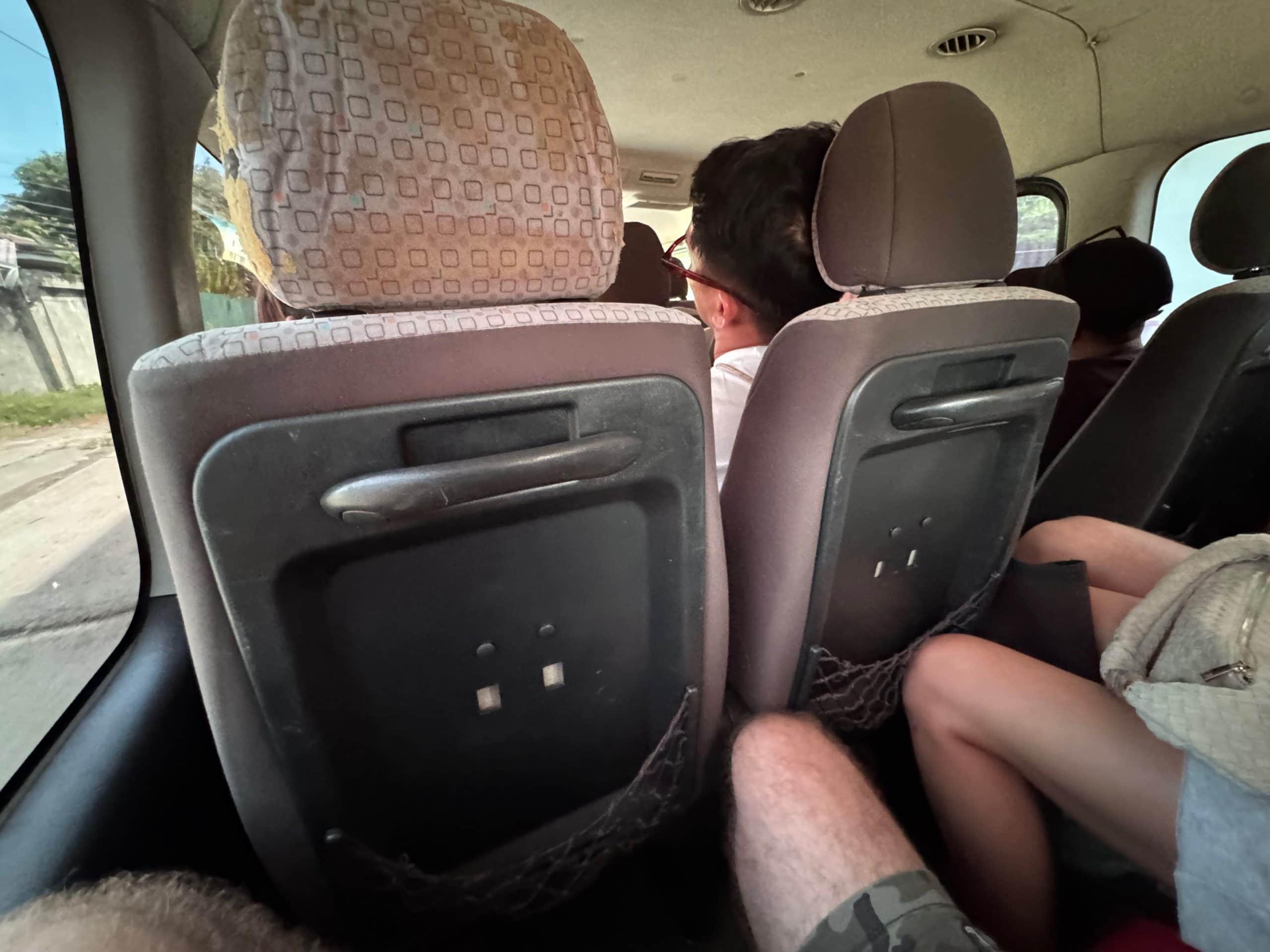 Cramped van ride from Puerto Princesa to El Nido showing tight seating and limited leg room Palawan Philippines