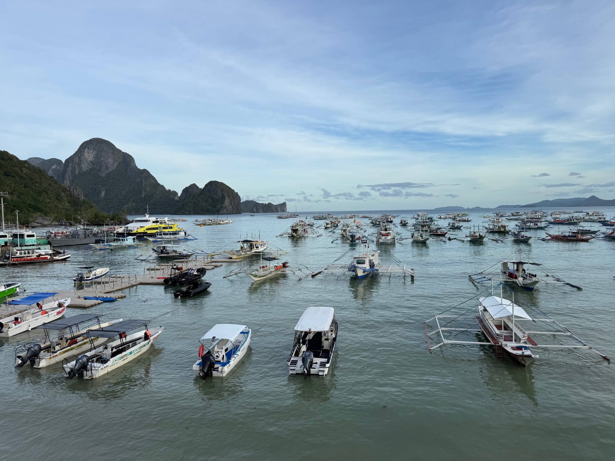 El Nido harbour with boats and limestone islands in the background Palawan Philippines