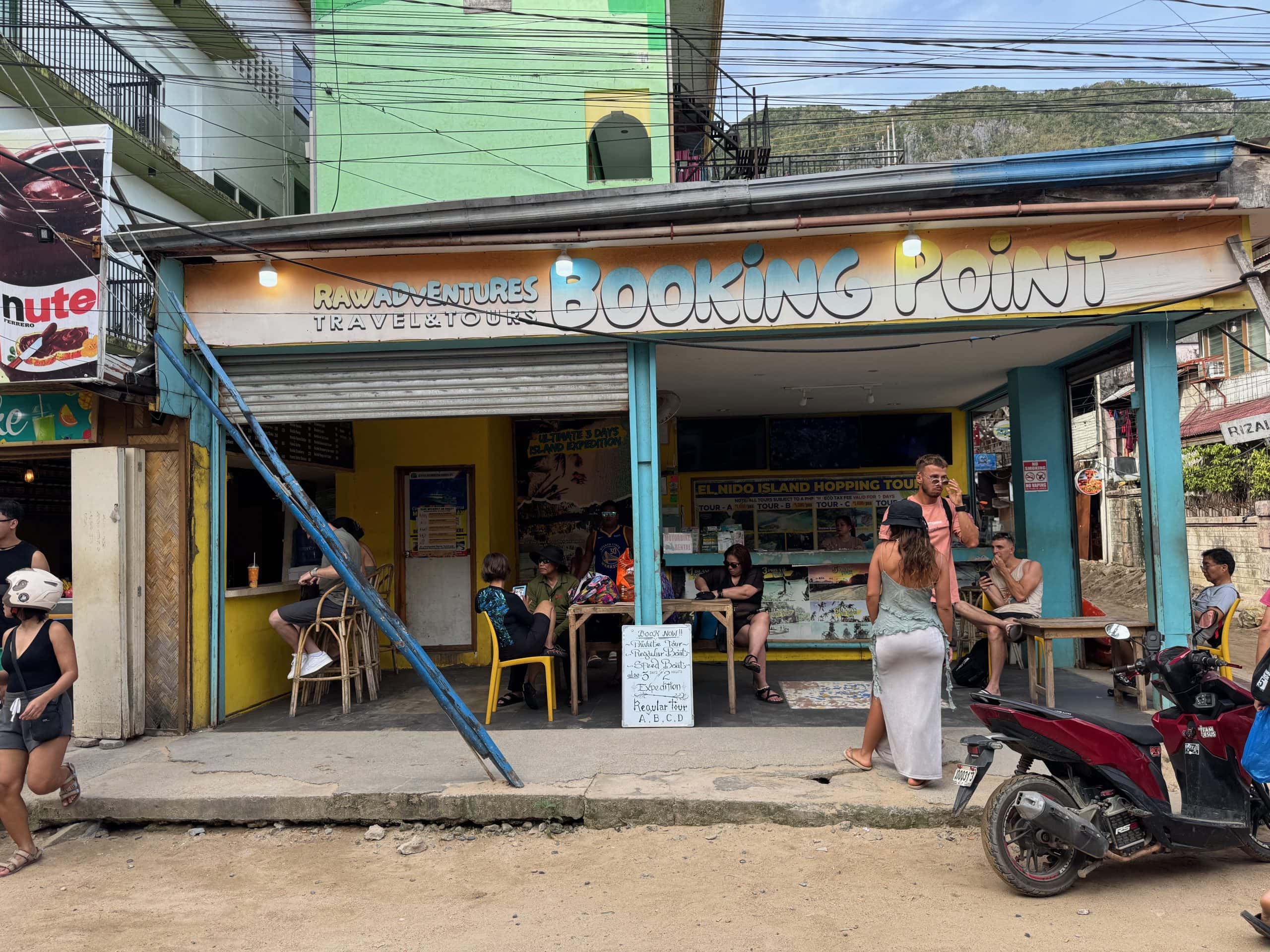 Local El Nido booking point for island hopping tours with travelers arranging Tour A B C and D trips in Palawan Philippines