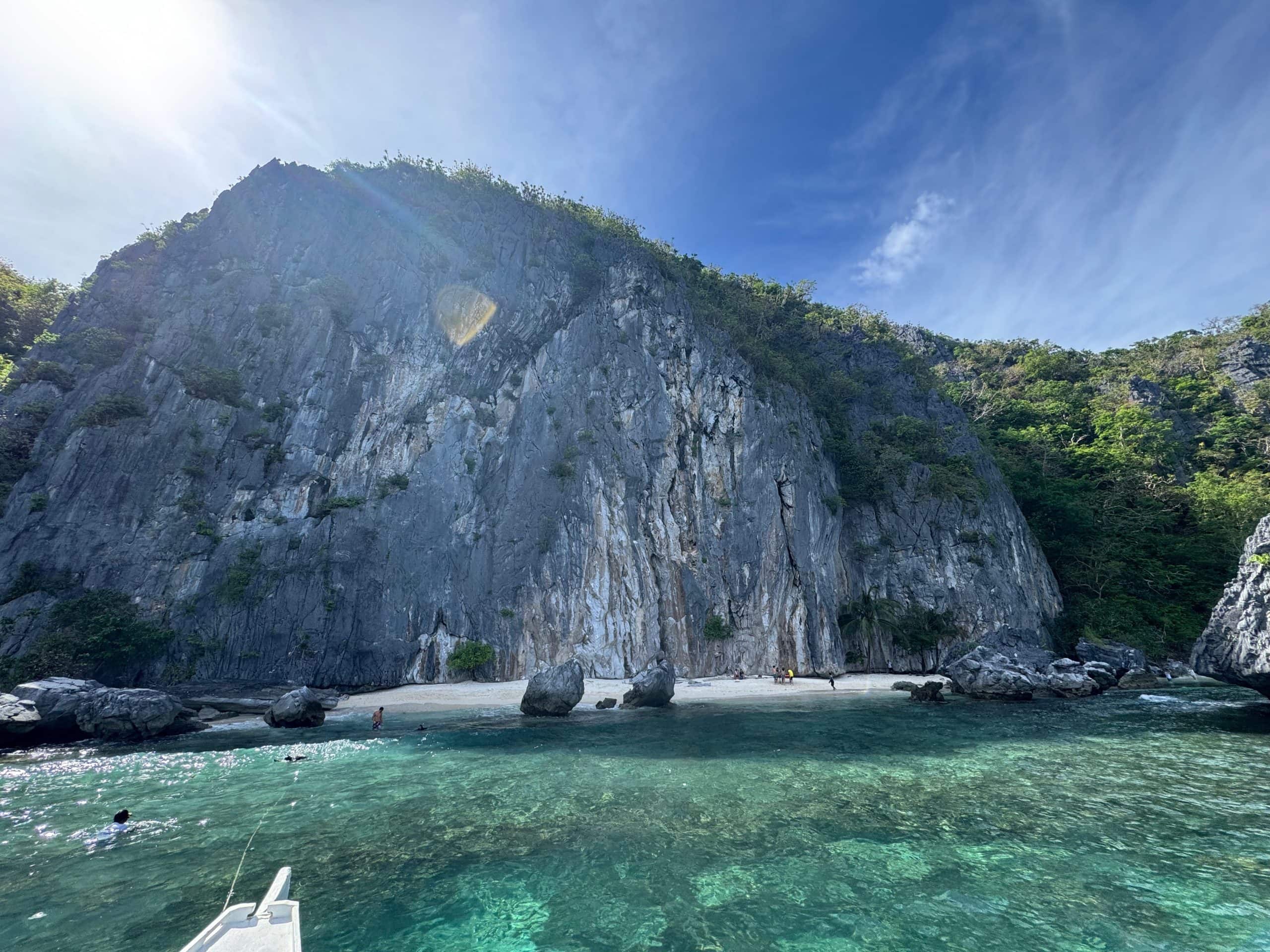 Talisay Beach in El Nido with clear turquoise water and towering limestone cliffs where we stopped for lunch during Tour C in Palawan Philippines