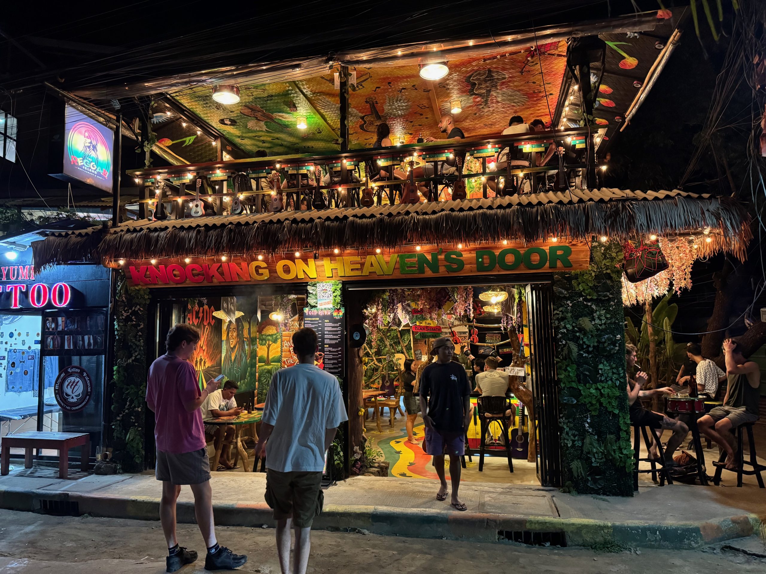 Lively nightlife scene in El Nido with colourful bars, music, and travellers enjoying the vibrant atmosphere after dark