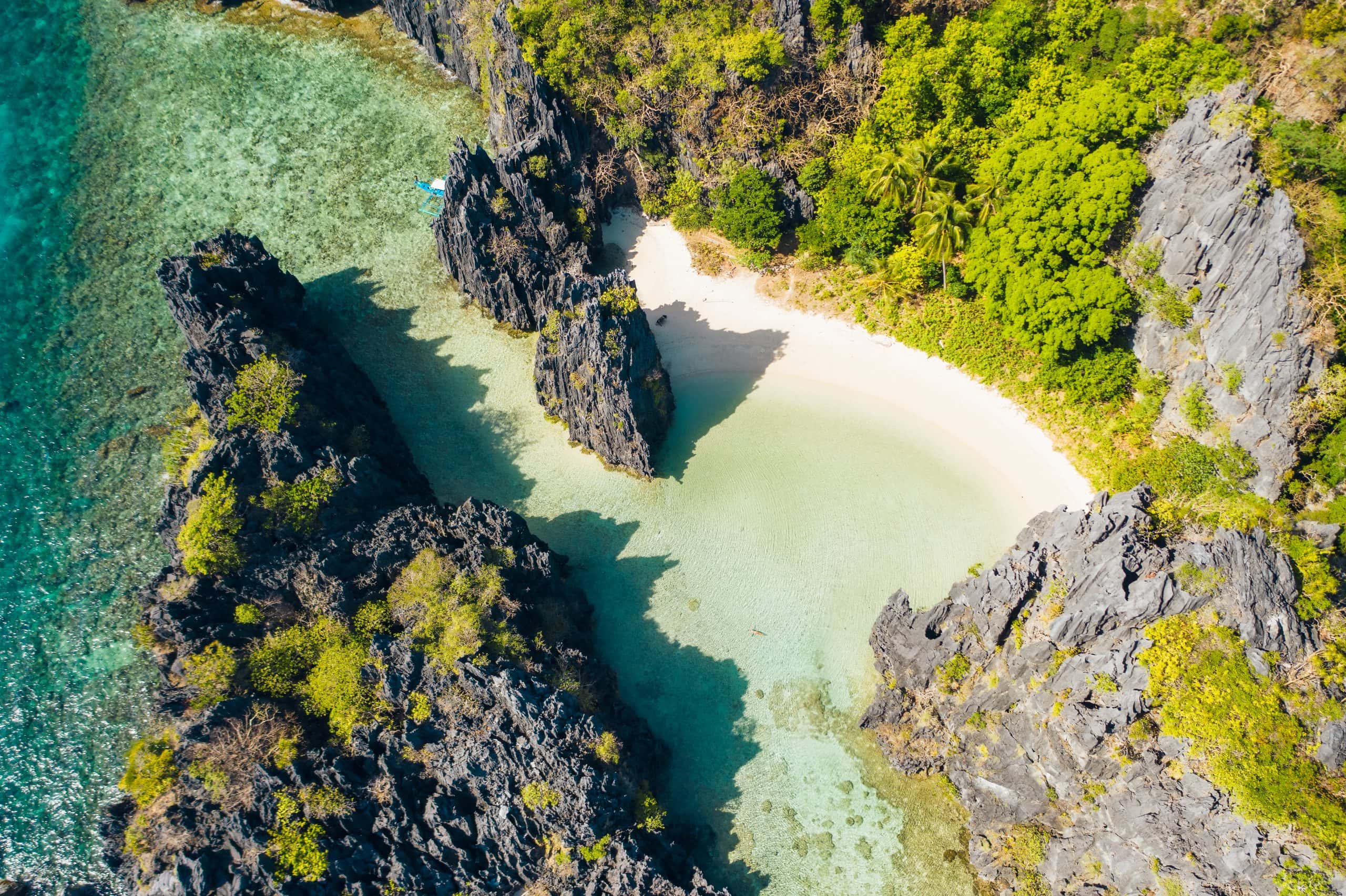 El Nido Palawan National Park. Hidden lagoon and lime stone rocks. White beach on tourist routes in the Philippines. Rocky formations on a tropical beach.
