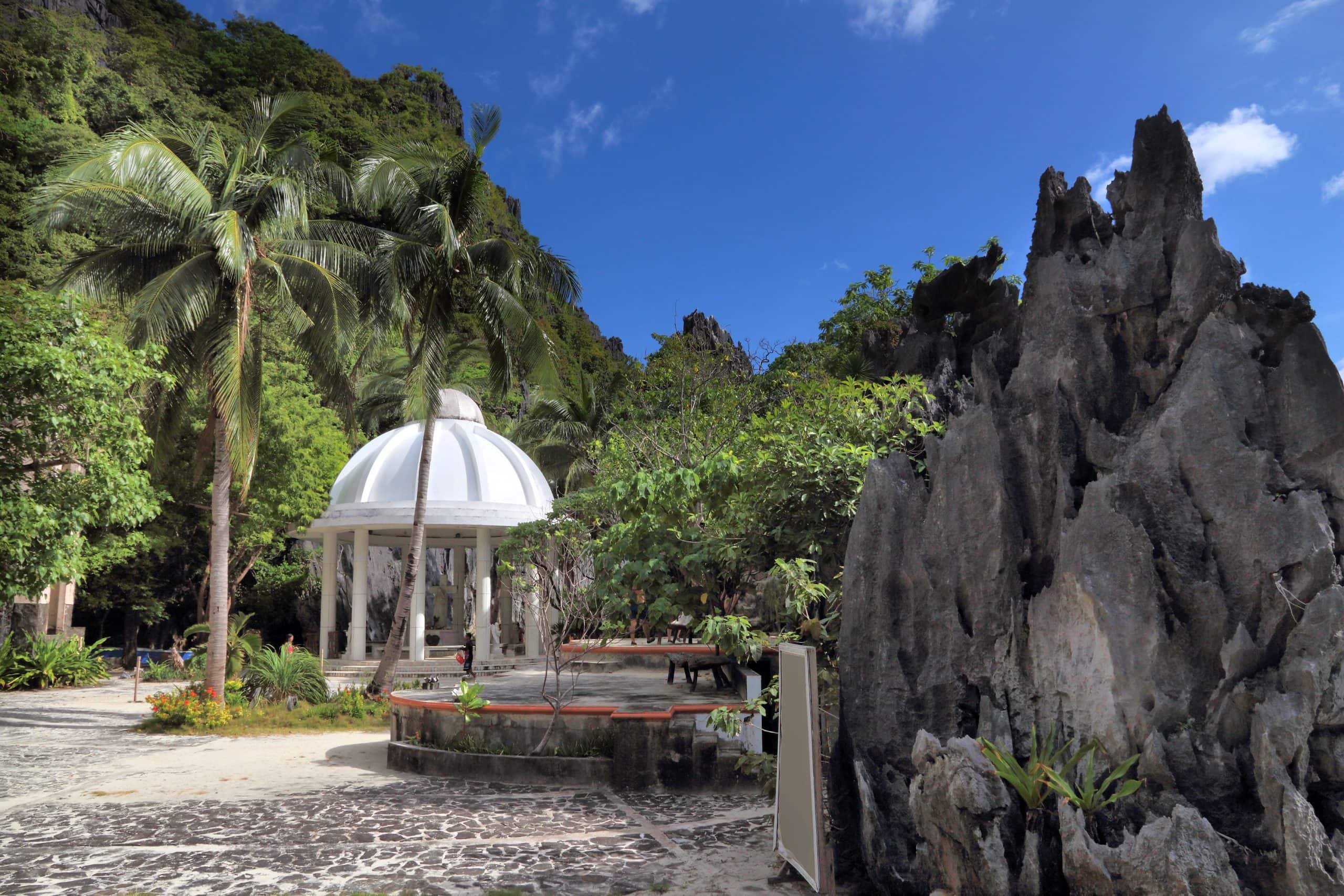 Matinloc Shrine in El Nido surrounded by limestone cliffs and tropical greenery on a secluded island in Palawan Philippines