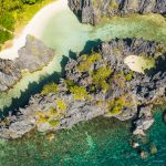 Aerial view of Hidden Beach and limestone cliffs in El Nido, Palawan, comparing the dramatic scenery of Tour A vs Tour C island hopping tours.
