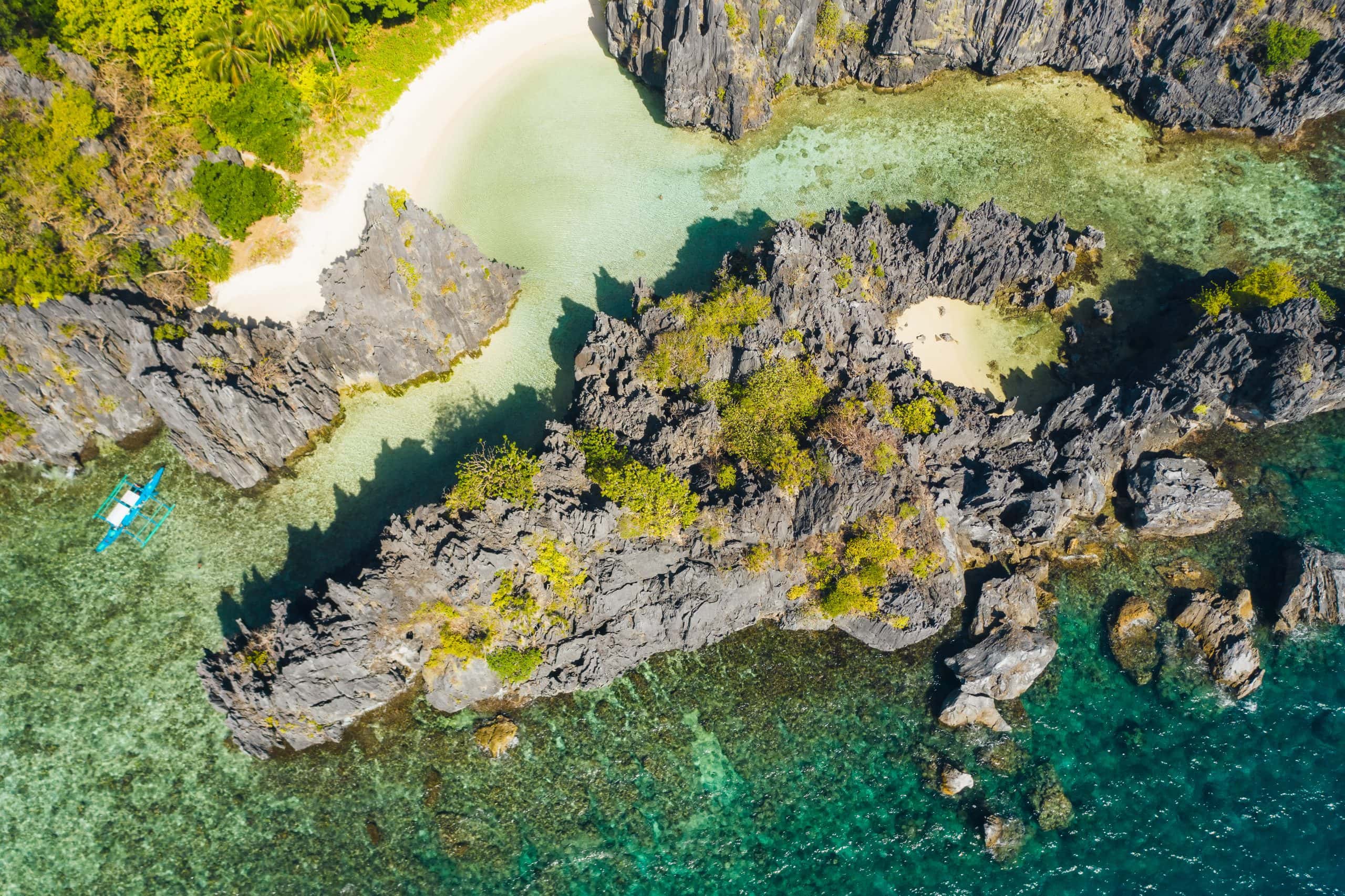 Aerial view of Hidden Beach and limestone cliffs in El Nido, Palawan, comparing the dramatic scenery of Tour A vs Tour C island hopping tours.