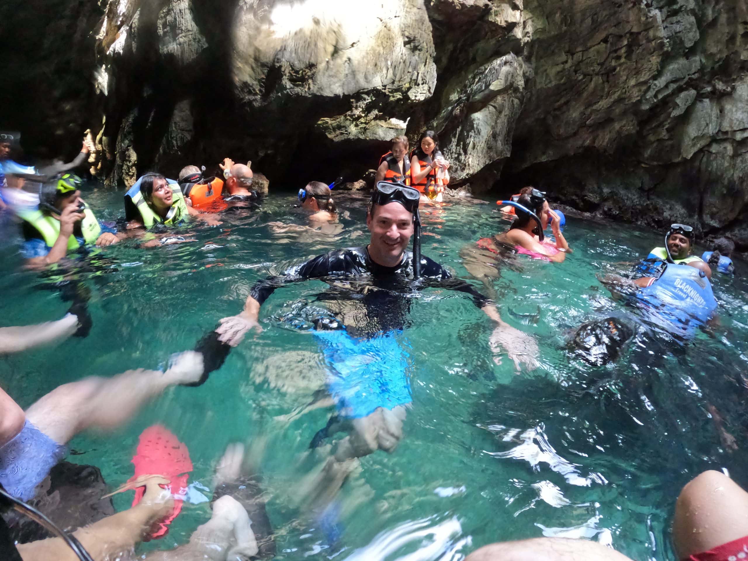Swimming inside Secret Lagoon during El Nido Tour A surrounded by limestone cliffs and crystal clear turquoise water in Palawan Philippines.