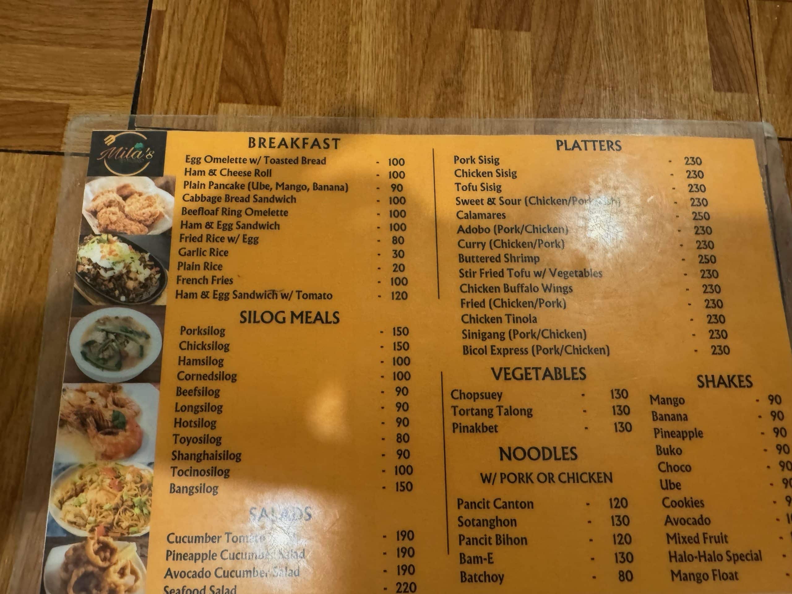 Local restaurant menu in the Philippines showing affordable Filipino meals, breakfast, noodles, vegetables and shakes priced in Philippine pesos.