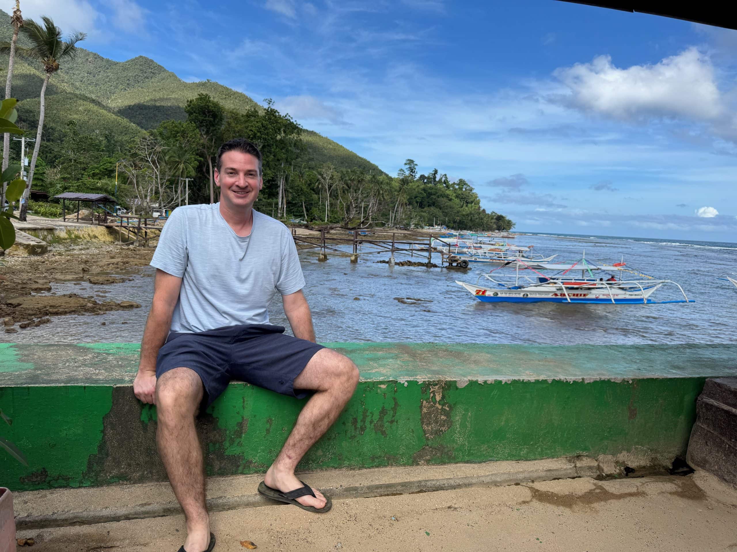 Boat departure area for the Puerto Princesa Underground River in Sabang, Palawan, with traditional outrigger boats along the coast.