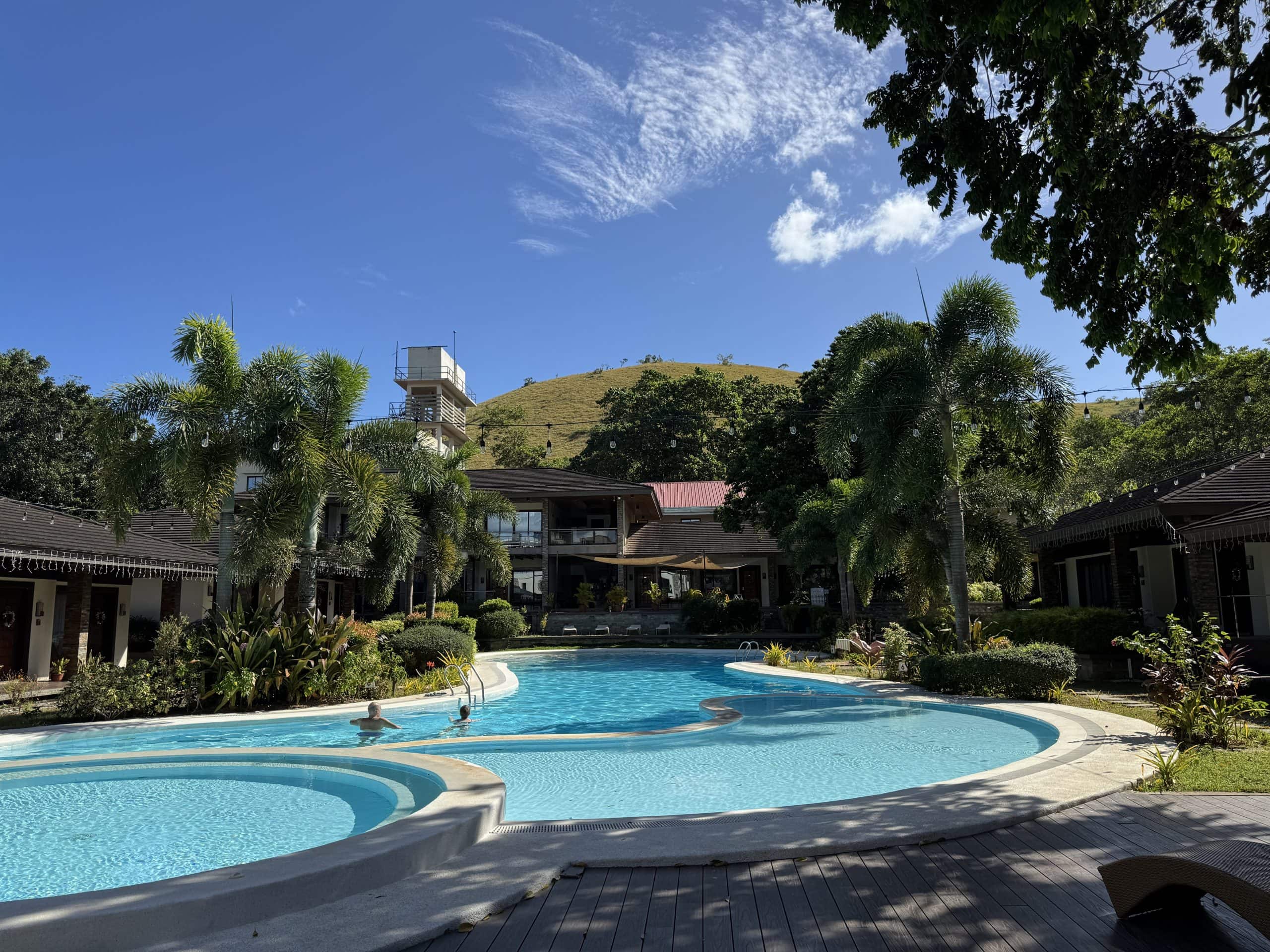 Mid range hotel with a swimming pool and tropical grounds in Coron, Palawan, Philippines.