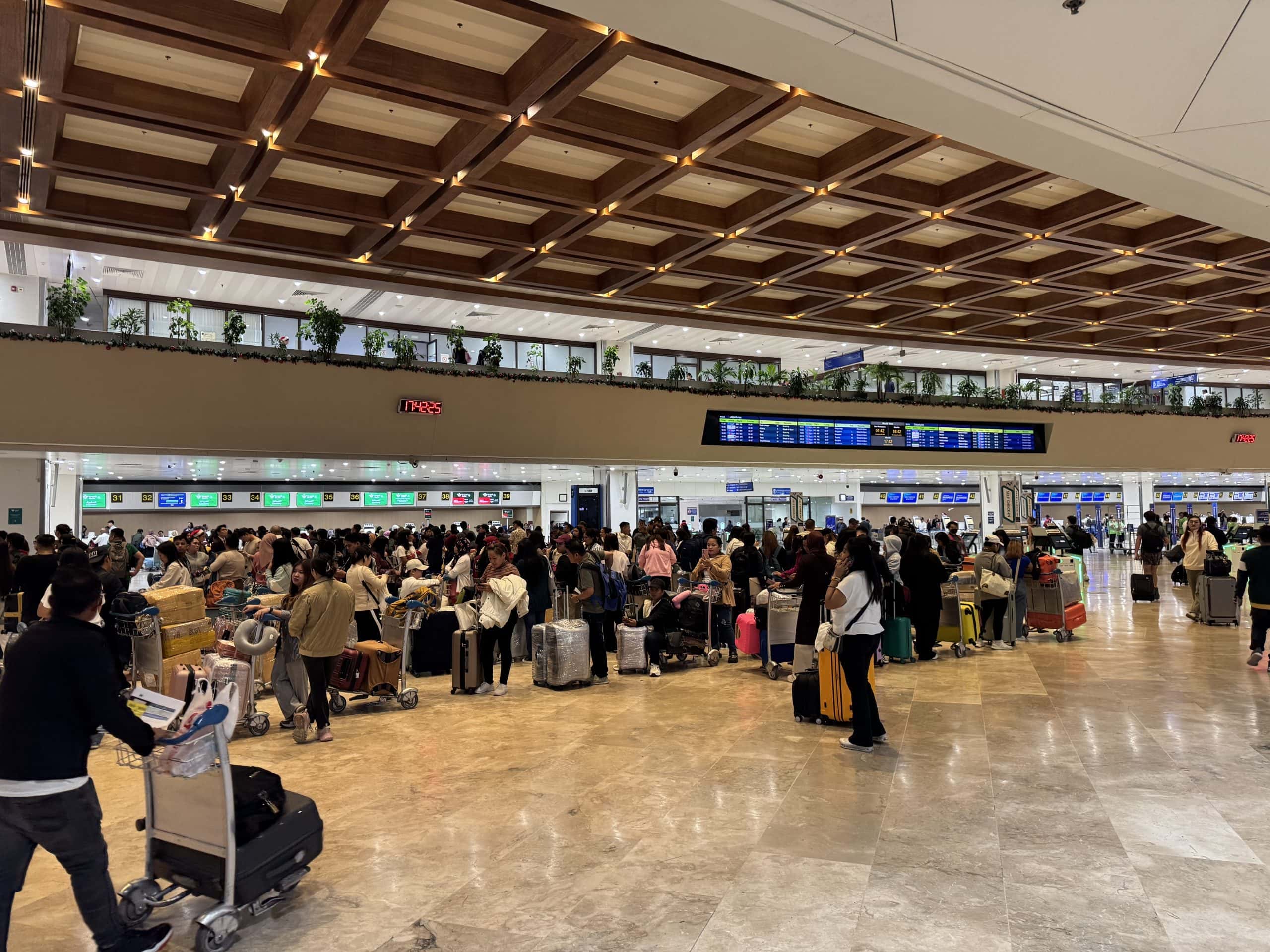 Busy check in area at Ninoy Aquino International Airport in Manila, showing the crowds travellers can encounter when flying through the Philippines.