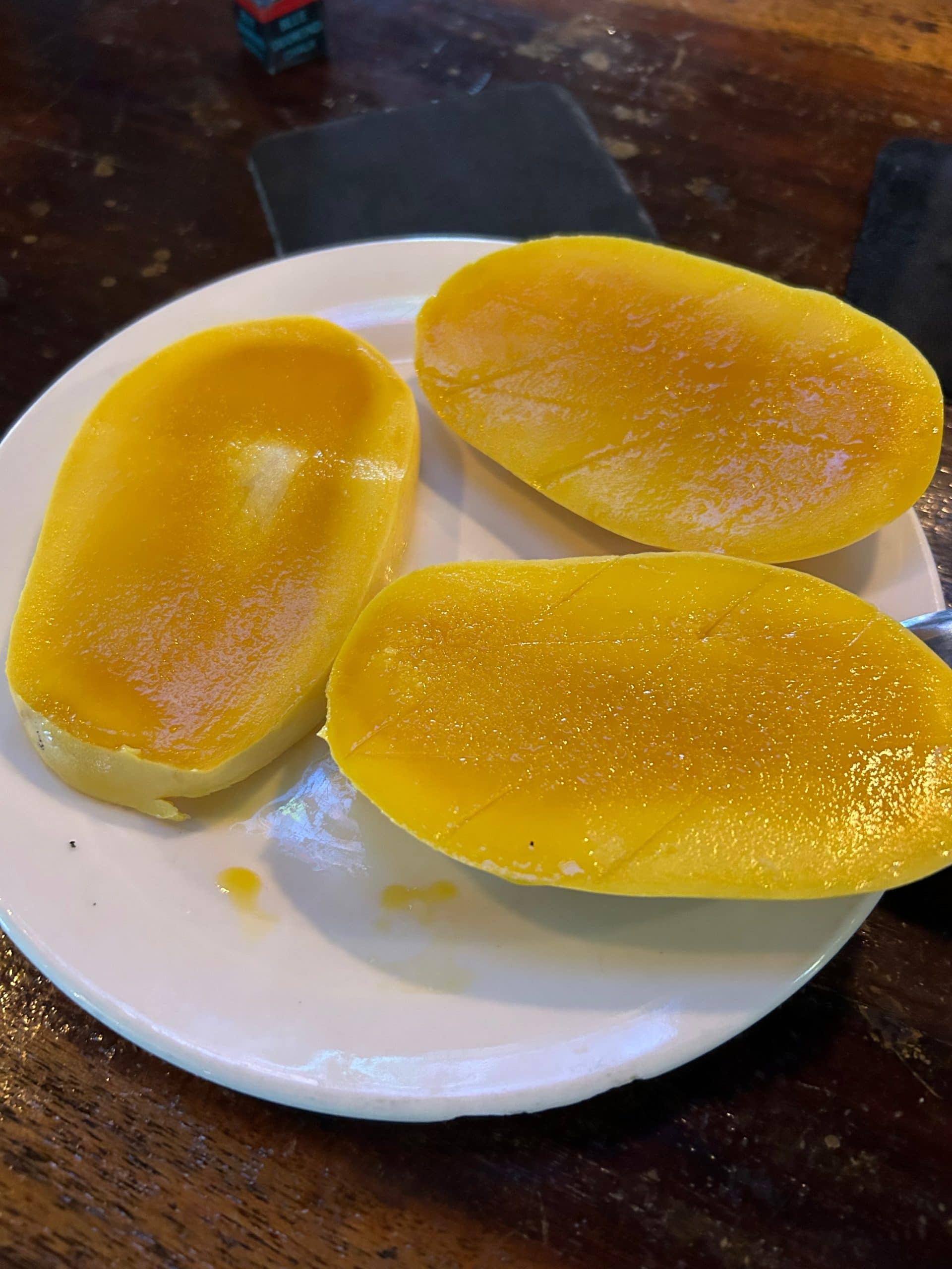 Fresh ripe Philippine mangoes cut open and served on a plate.