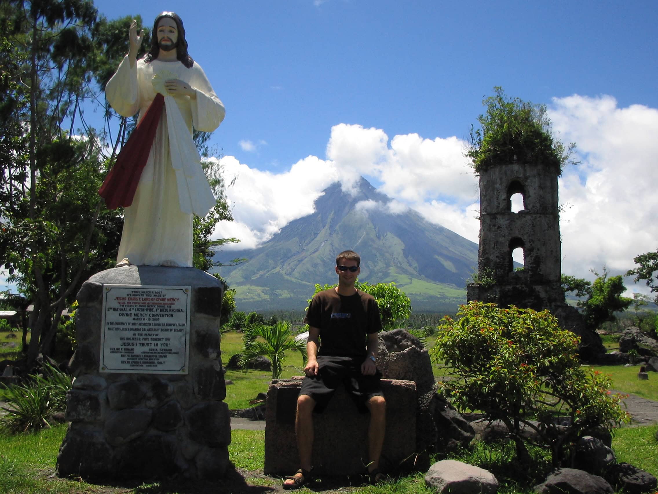 Visiting the Cagsawa Ruins with Mayon Volcano rising in the background near Legazpi, Luzon, Philippines.