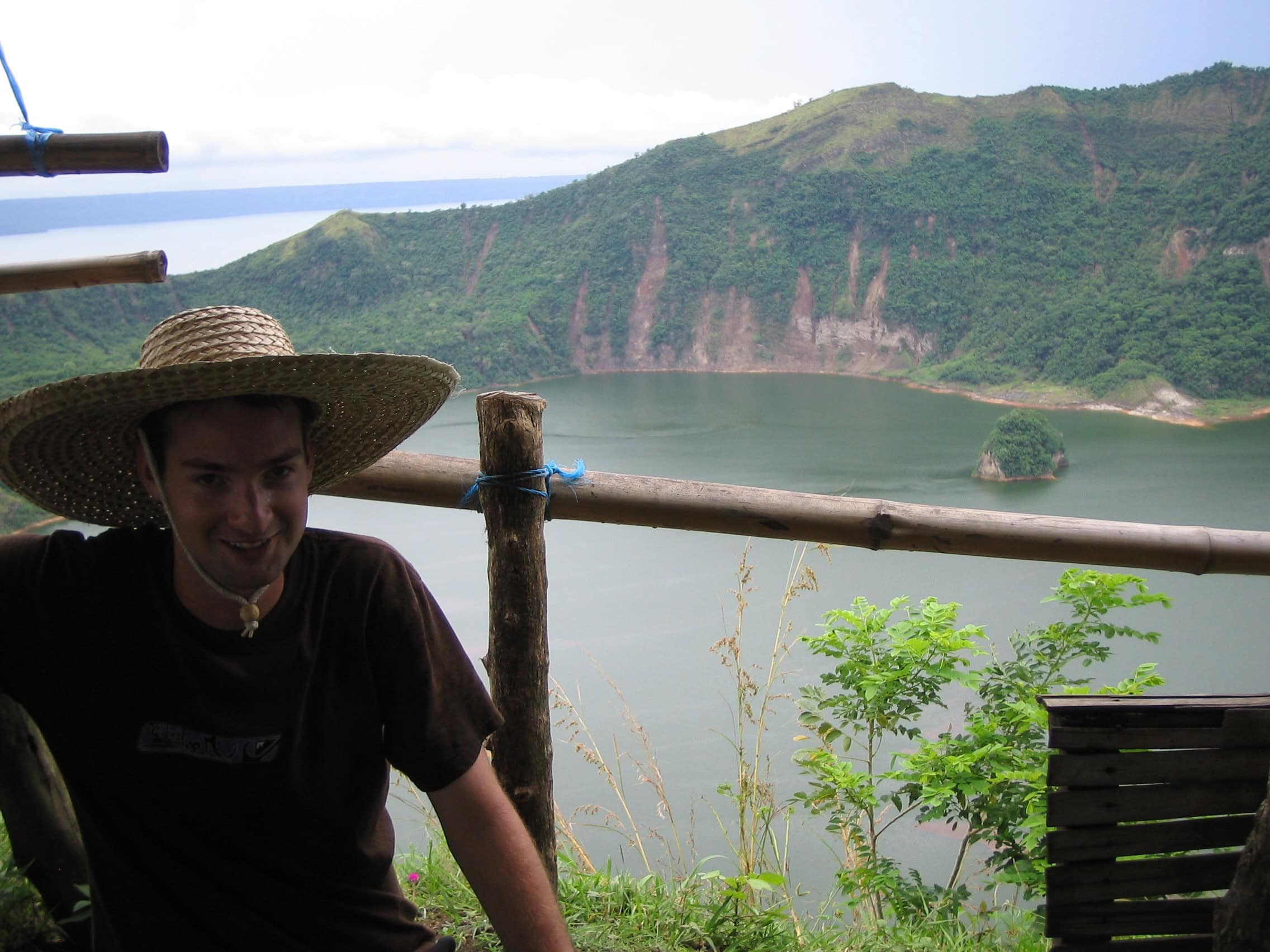 Visiting Taal Volcano on Luzon, Philippines, with the crater lake and surrounding green volcanic landscape in the background.