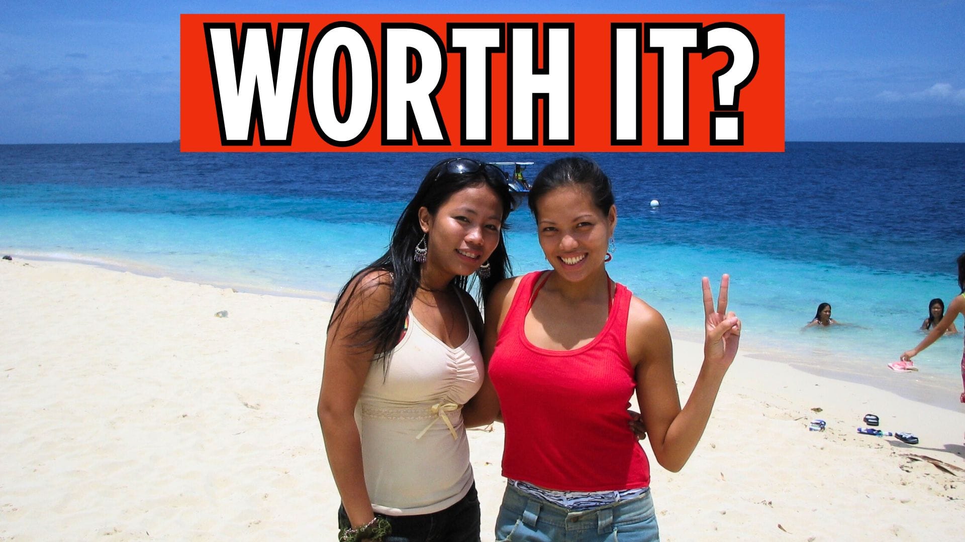 Sunny beach in Bohol with visitors enjoying the white sand and clear blue water.