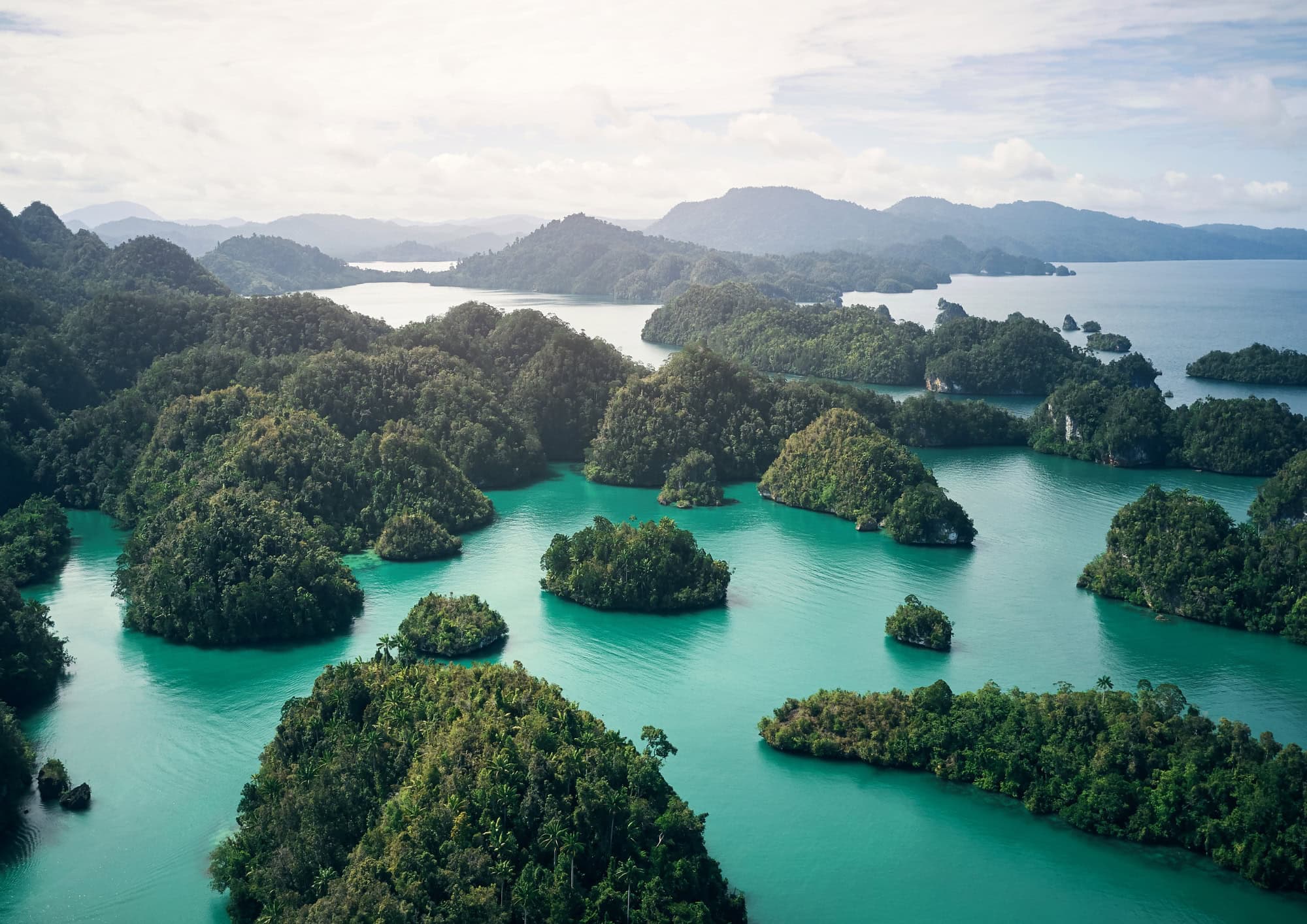 Tropical limestone islands surrounded by turquoise water, representing world class scuba diving destinations and dive travel guides.