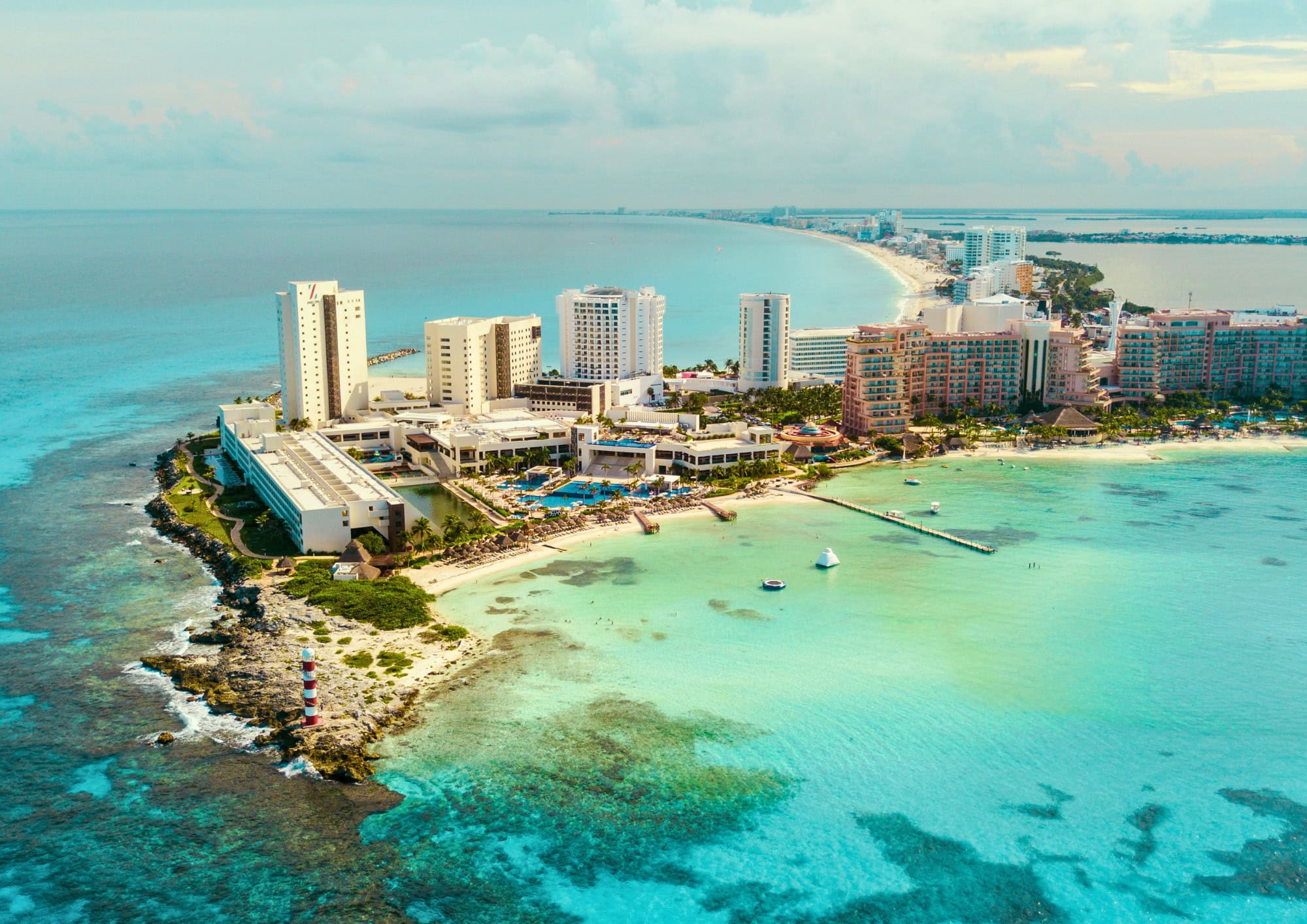 Aerial view of Cancun's Caribbean coastline with turquoise water, beaches and resorts, representing scuba diving and travel in Mexico.