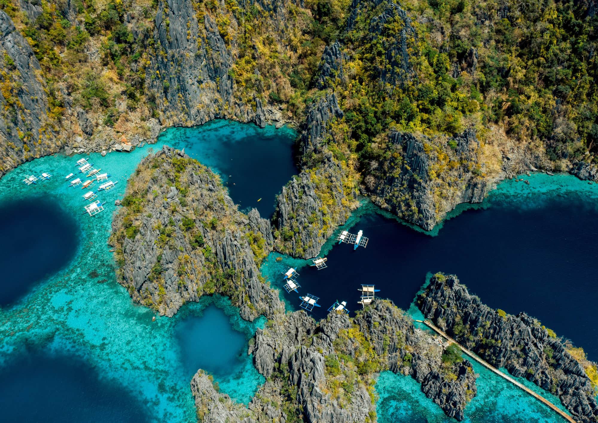 Aerial view of Coron's crystal clear lagoons surrounded by dramatic limestone islands.